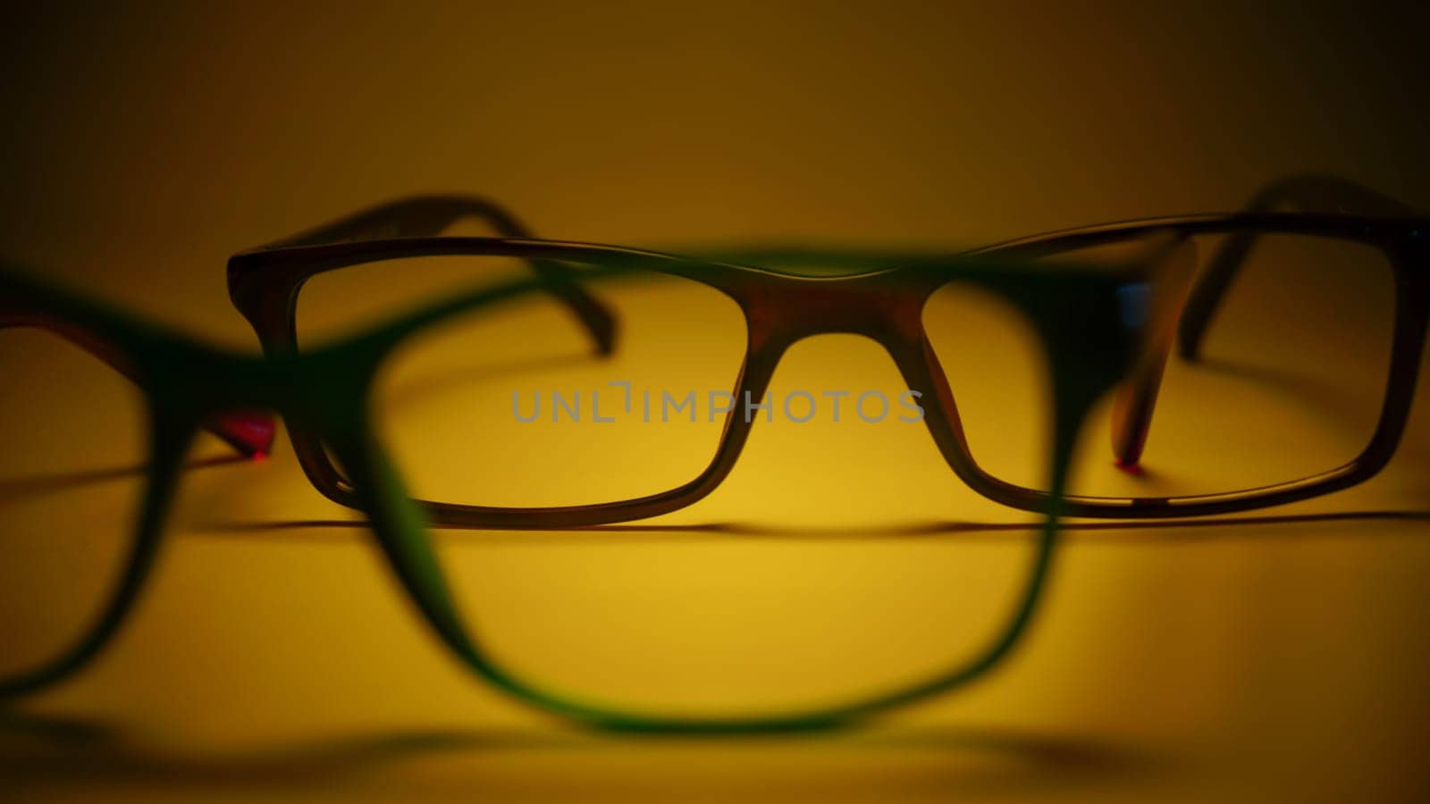 Rimmed eyeglasses closeup on a white background abstract view