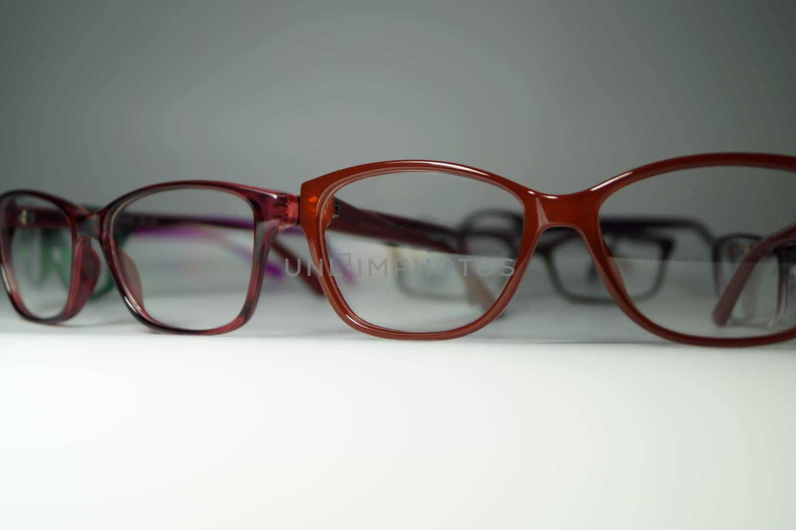Rimmed eyeglasses closeup on a white background abstract view