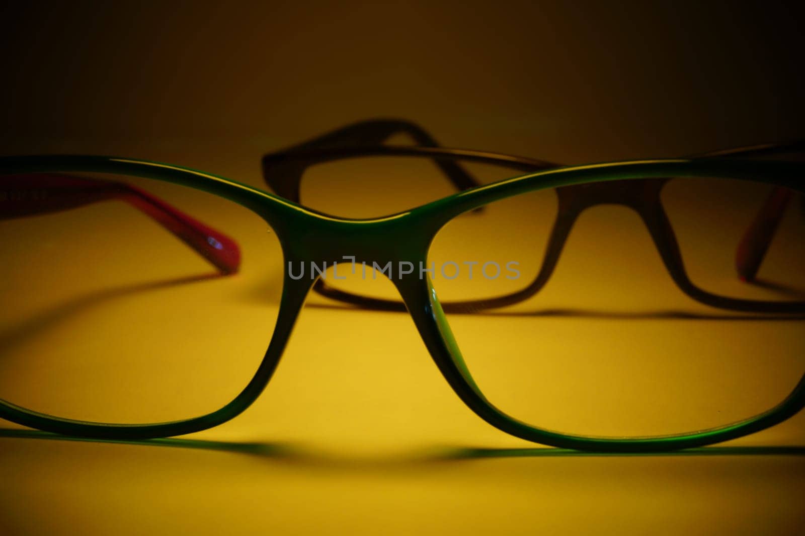 Rimmed eyeglasses closeup on a white background abstract view