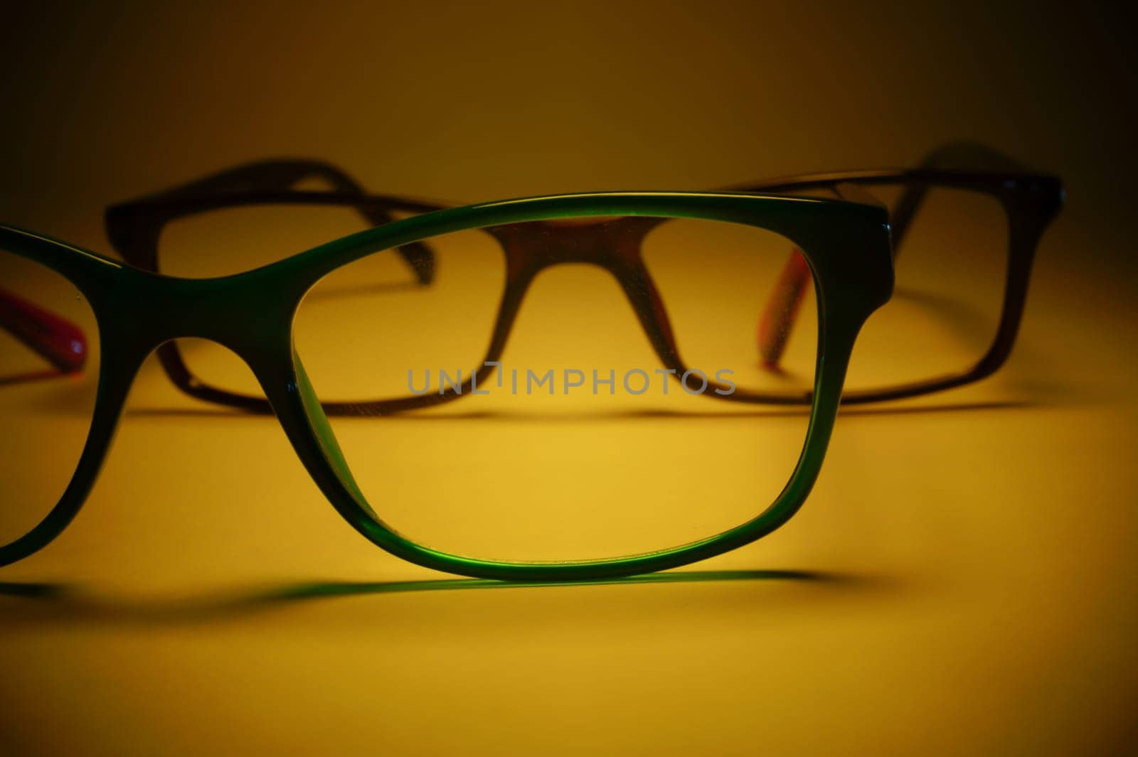 Rimmed eyeglasses closeup on a white background abstract view