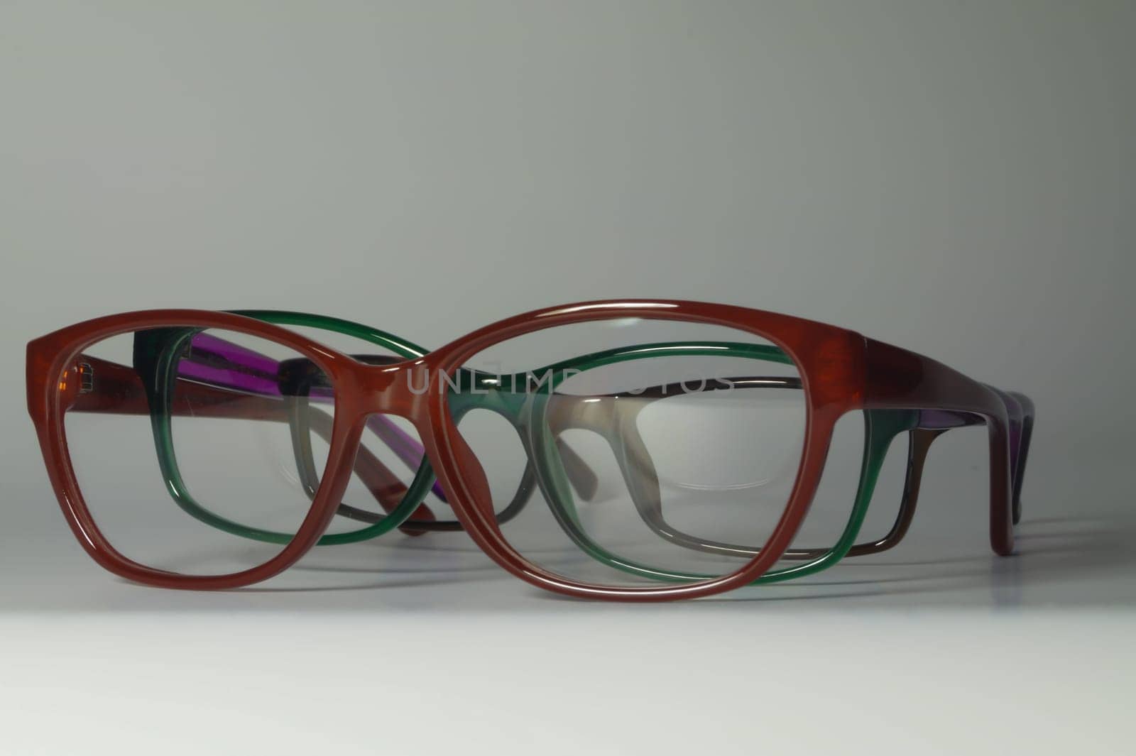 Rimmed eyeglasses closeup on a white background abstract view