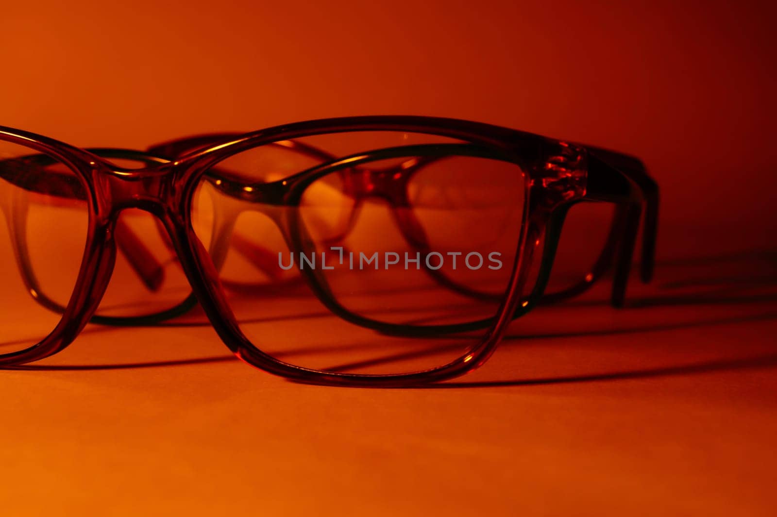 Rimmed eyeglasses closeup on a white background abstract view