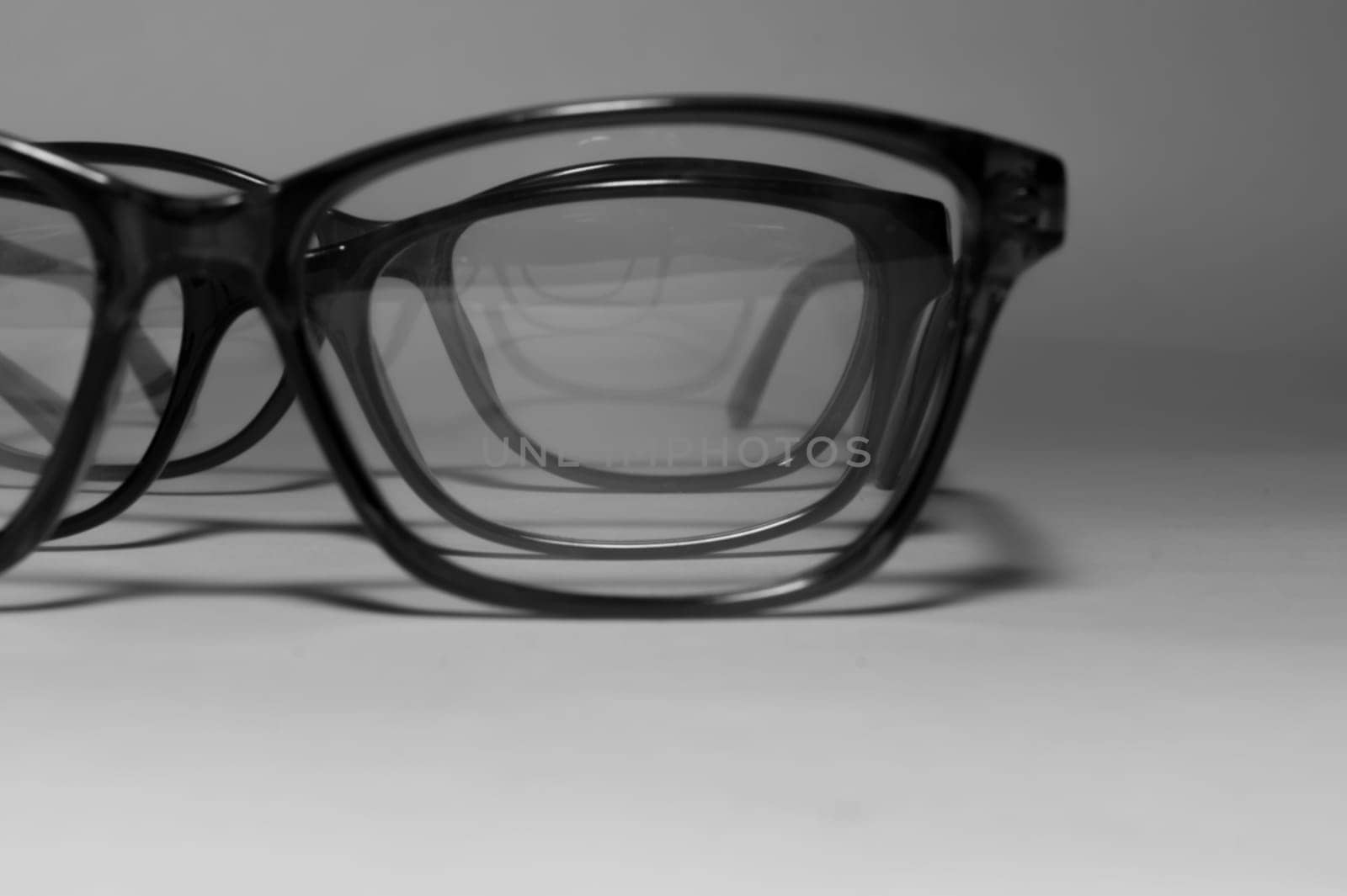 Rimmed eyeglasses closeup on a white background abstract view