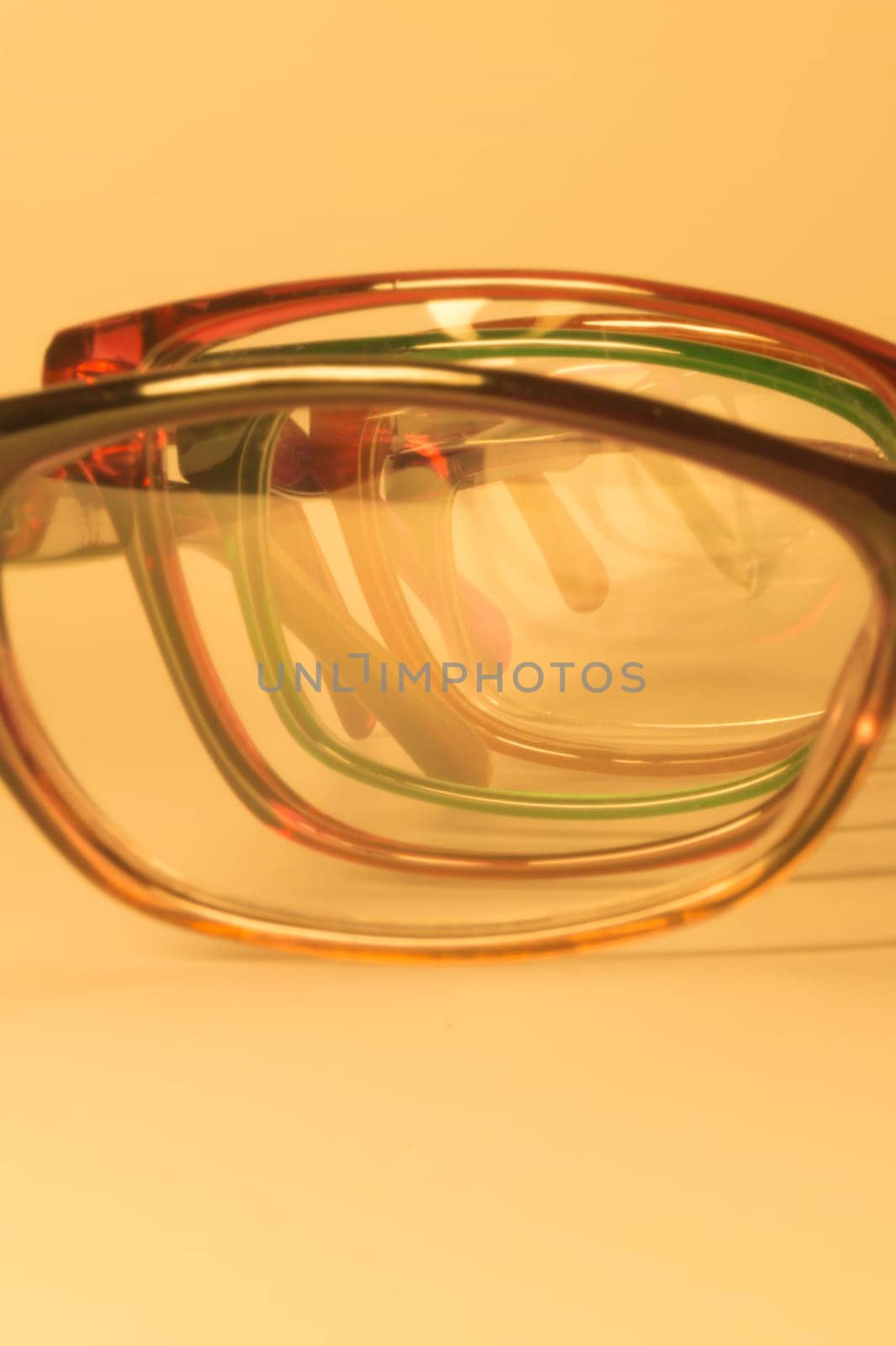 Rimmed eyeglasses closeup on a white background abstract view