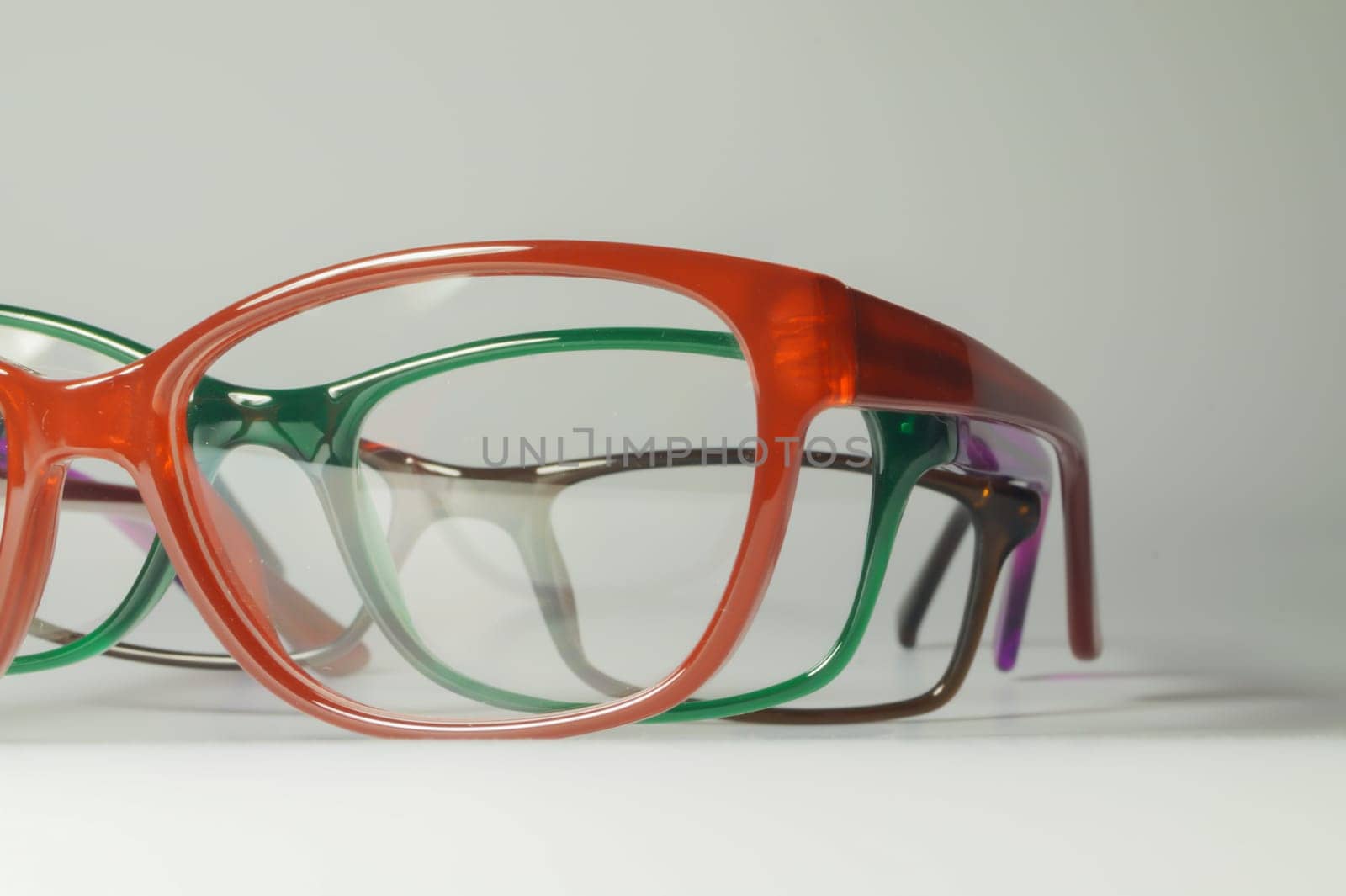 Rimmed eyeglasses closeup on a white background abstract view