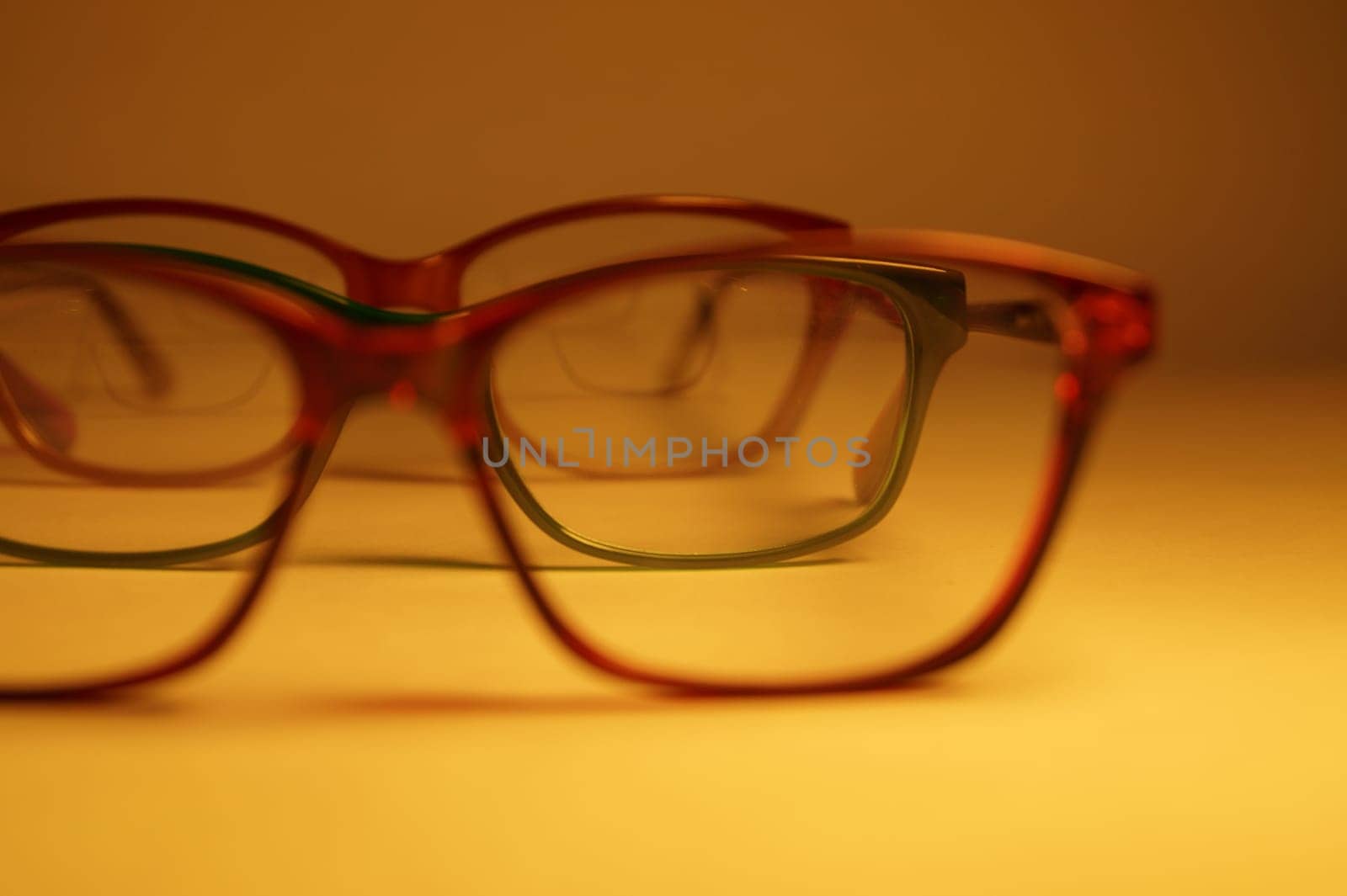 Rimmed eyeglasses closeup on a white background abstract view