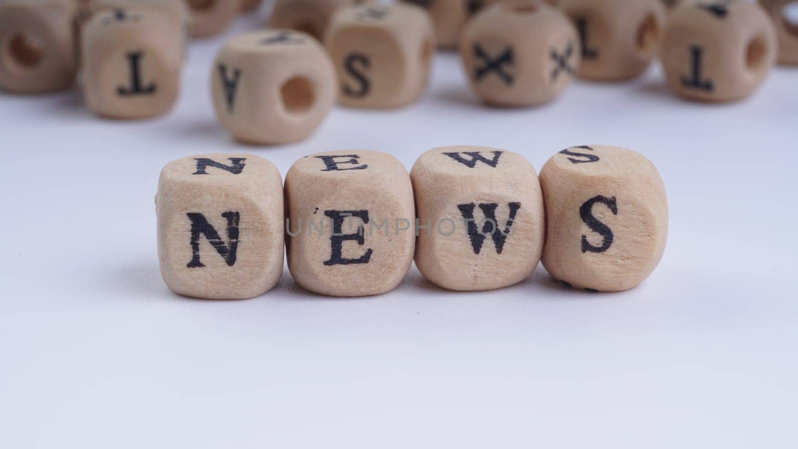 GST inscription on wooden alphabet over white background with selective focus