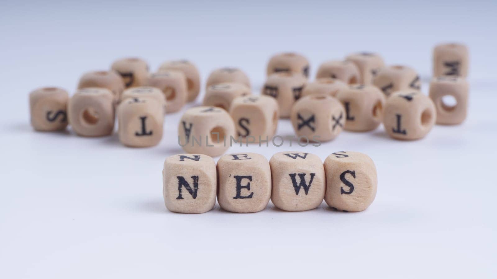 GST inscription on wooden alphabet over white background with selective focus
