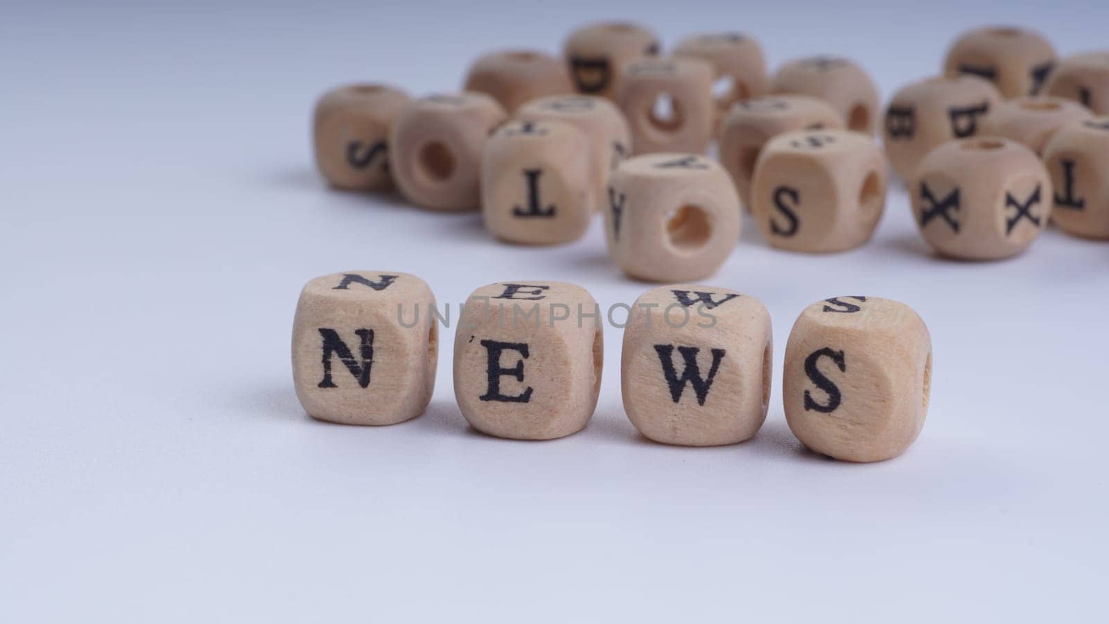 GST inscription on wooden alphabet over white background with selective focus