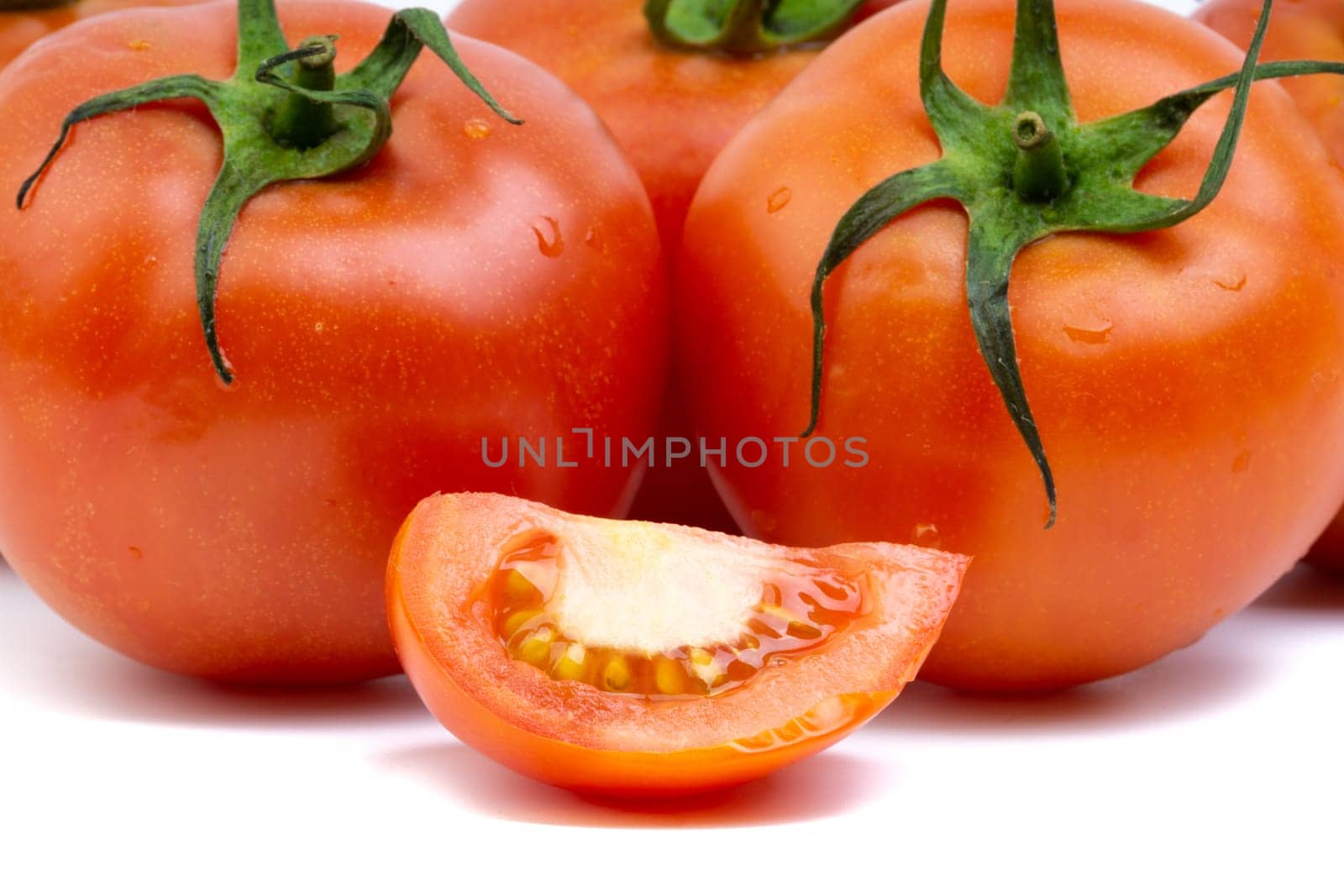 Tomato closeup on white background. Selective focus and crop fragment