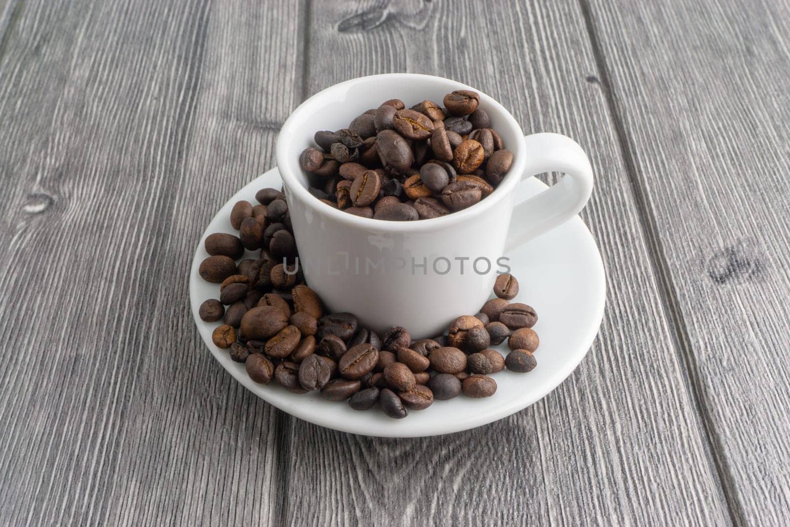 Coffee cup and coffee beans on wooden background. Top view and selective focus
