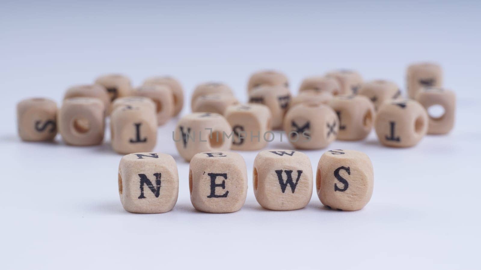 GST inscription on wooden alphabet over white background with selective focus