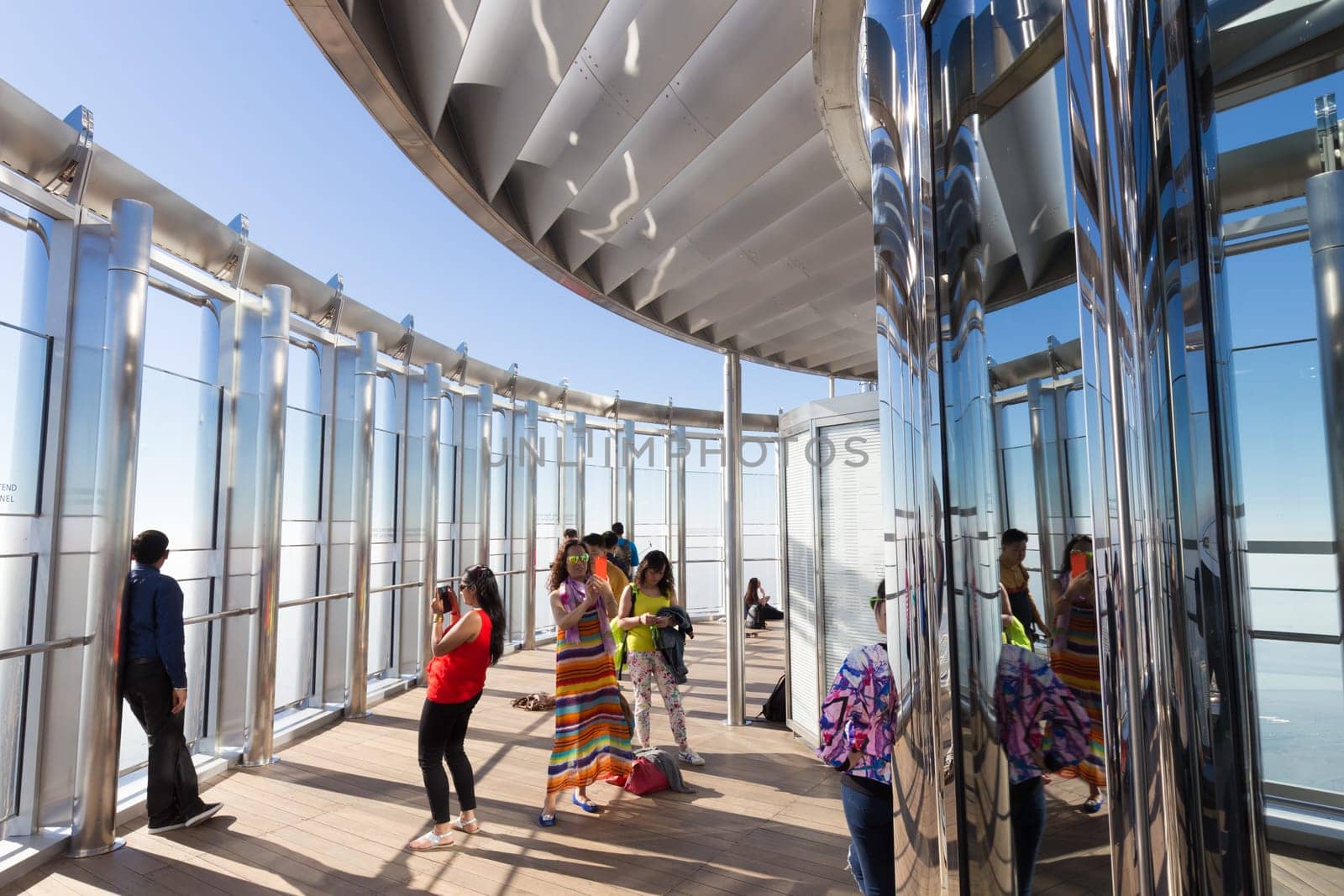 Dubai, UAE - Feb 21, 2016: Tourists taking photos of Dubai from the top the observation deck of the highest building in the world,Burj Khalifa in Dubai, UAE on 21nd of February, 2016.