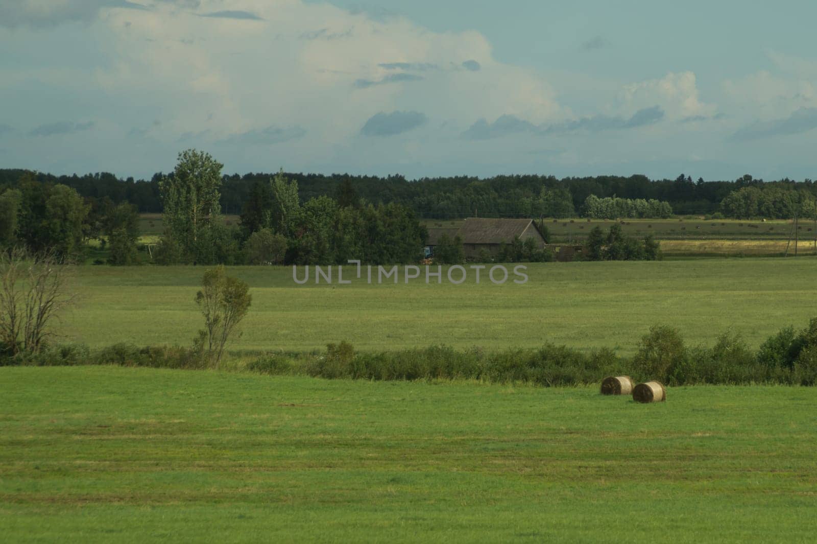 Country landscape with haystacks on the field background
