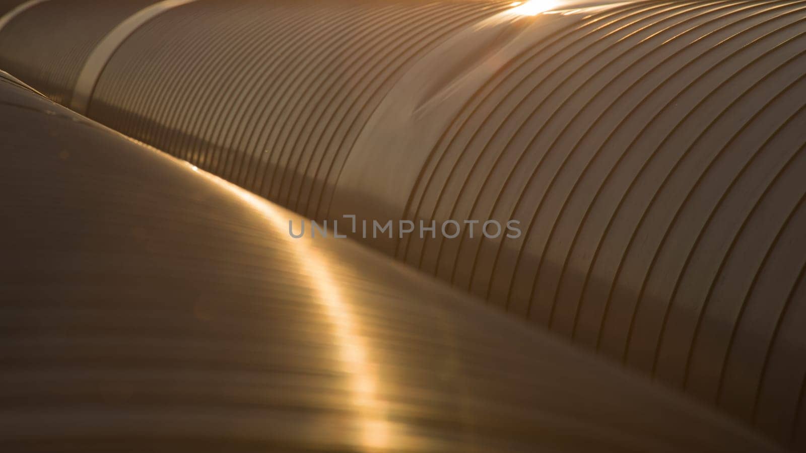 Golden metal pipes closeup background