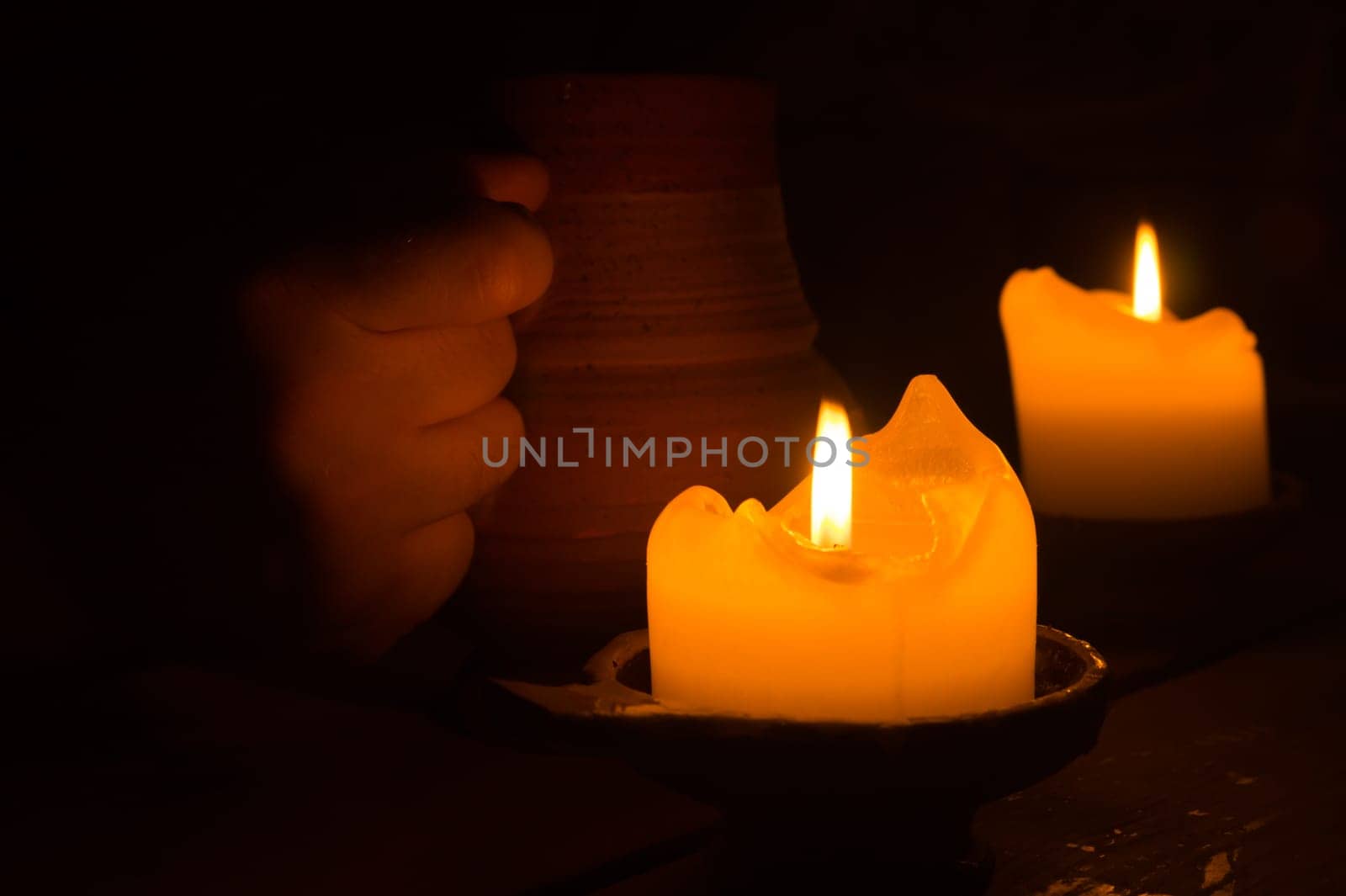 Burning candle in the dark