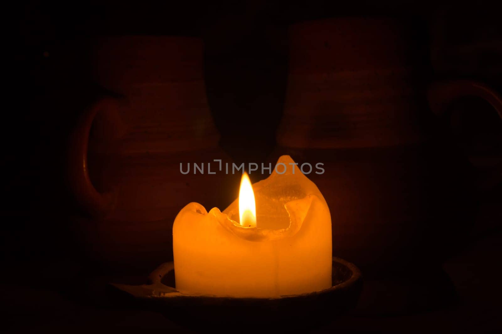 Burning candle in the dark