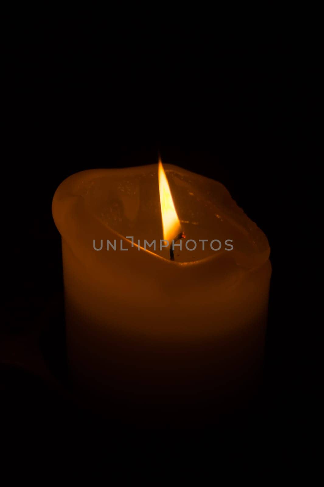 Burning candle in the dark