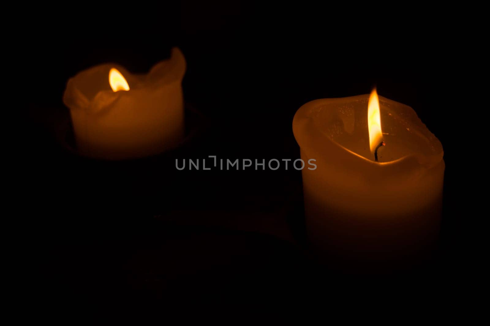 Burning candle in the dark