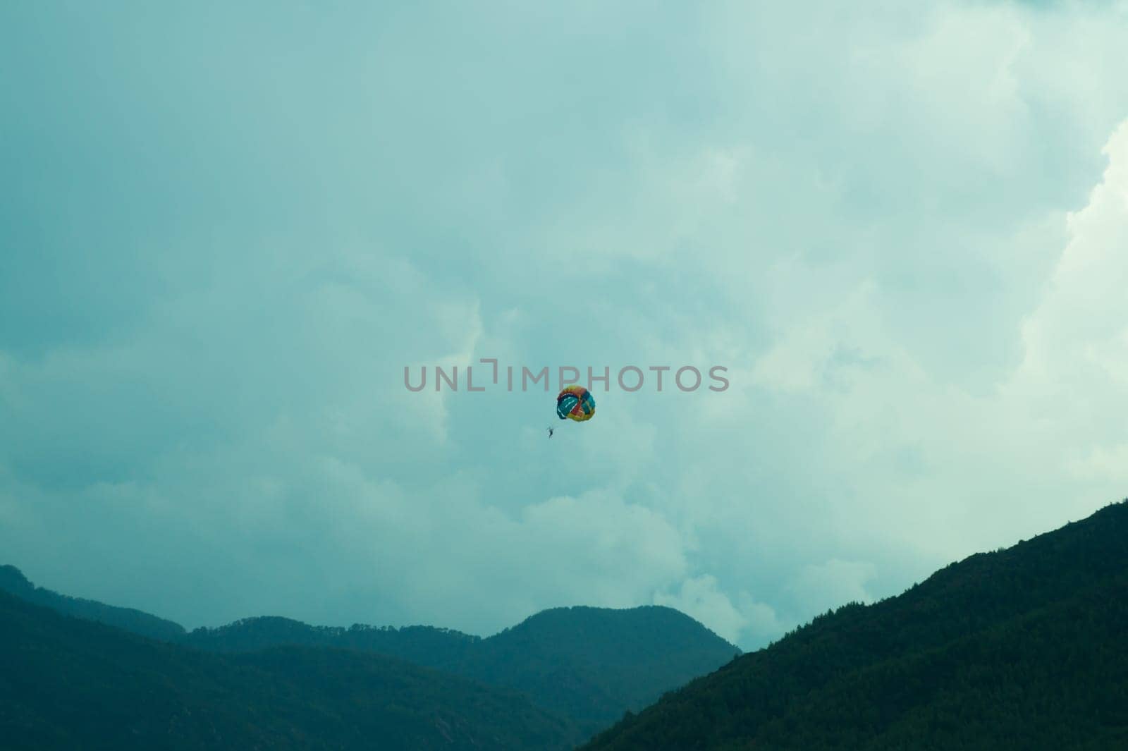 Skydiver flying with a colorful parachute