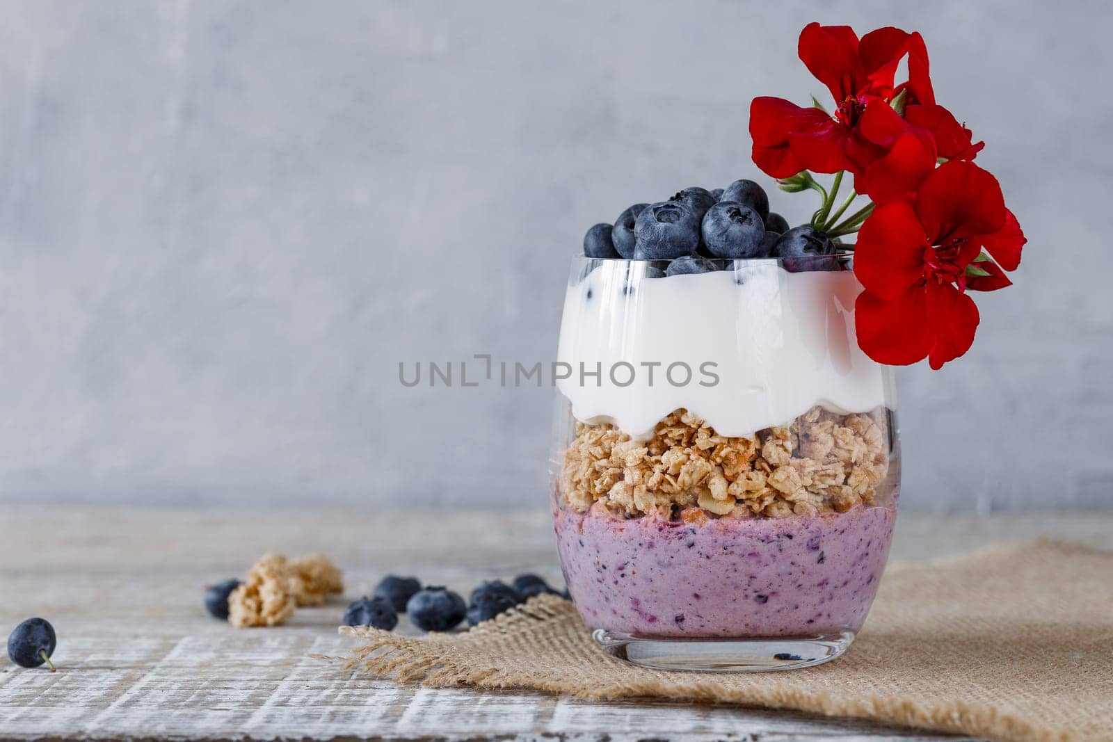 Granola with yogurt and blueberriesGranola with yogurt and blueberries in a glass beaker