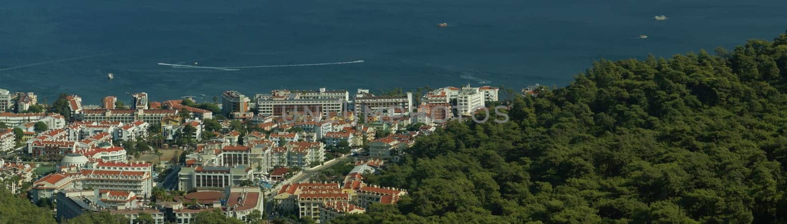 Nature landscape with a city by the shore of the sea between the hills. mountain town panorama