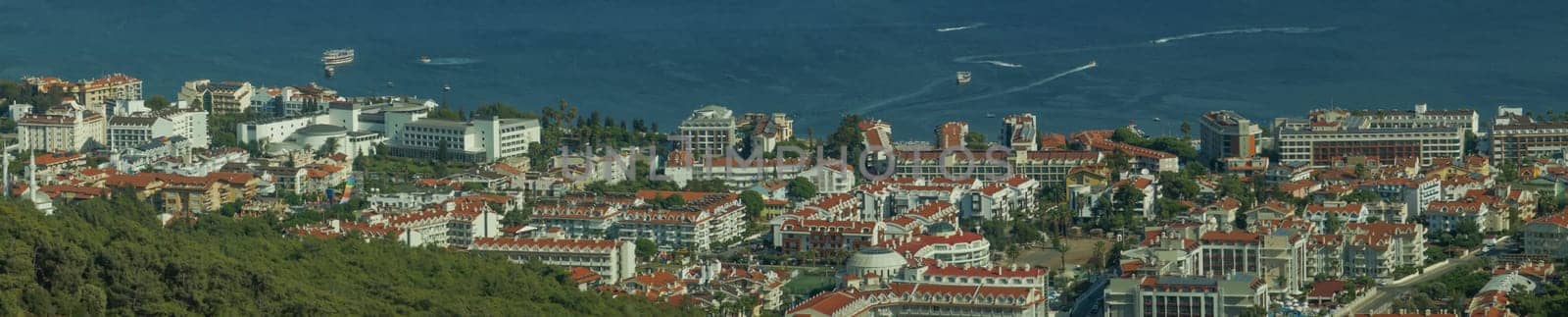 Nature landscape with a city by the shore of the sea between the hills. mountain town panorama