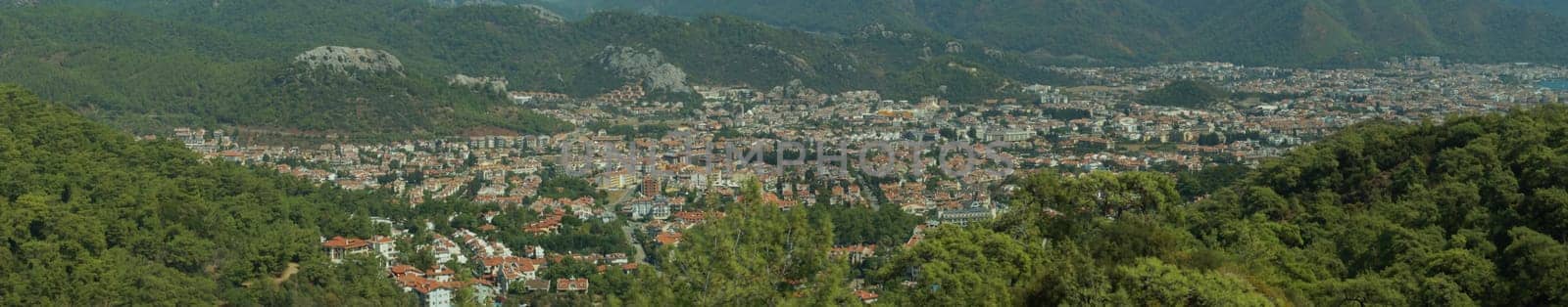Mountain town panorama. landscape with a city between the hills