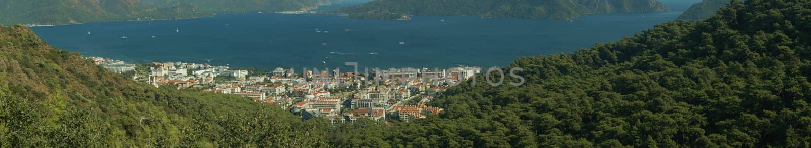 Nature landscape with a city by the shore of the sea between the hills. mountain town panorama