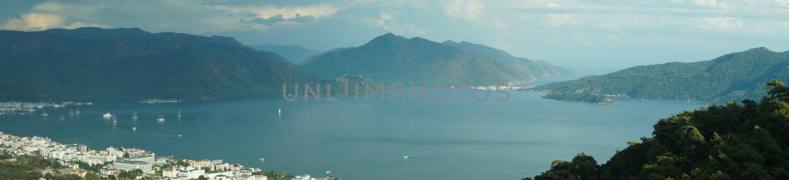 Nature landscape with a city by the shore of the sea between the hills. mountain town panorama