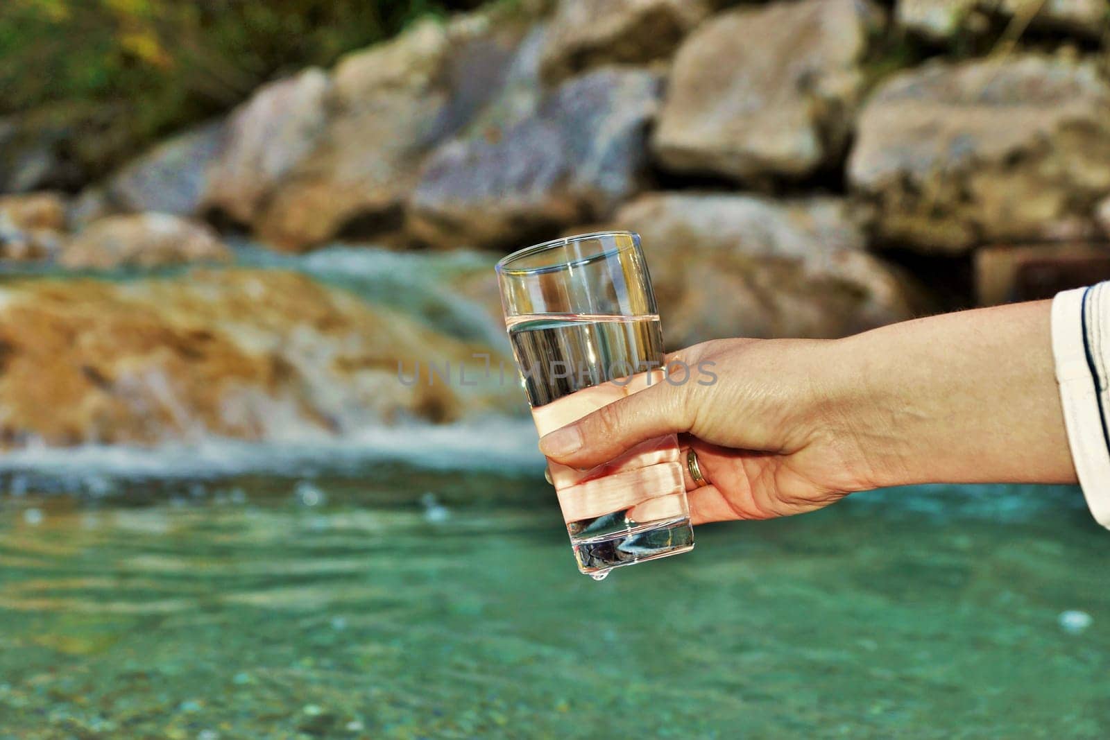 Woman's hand is holding a water glass