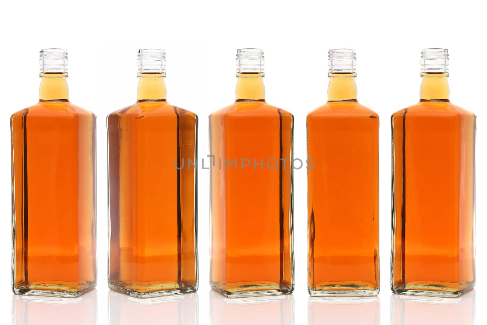 Row of glass bottle whiskey on a white background