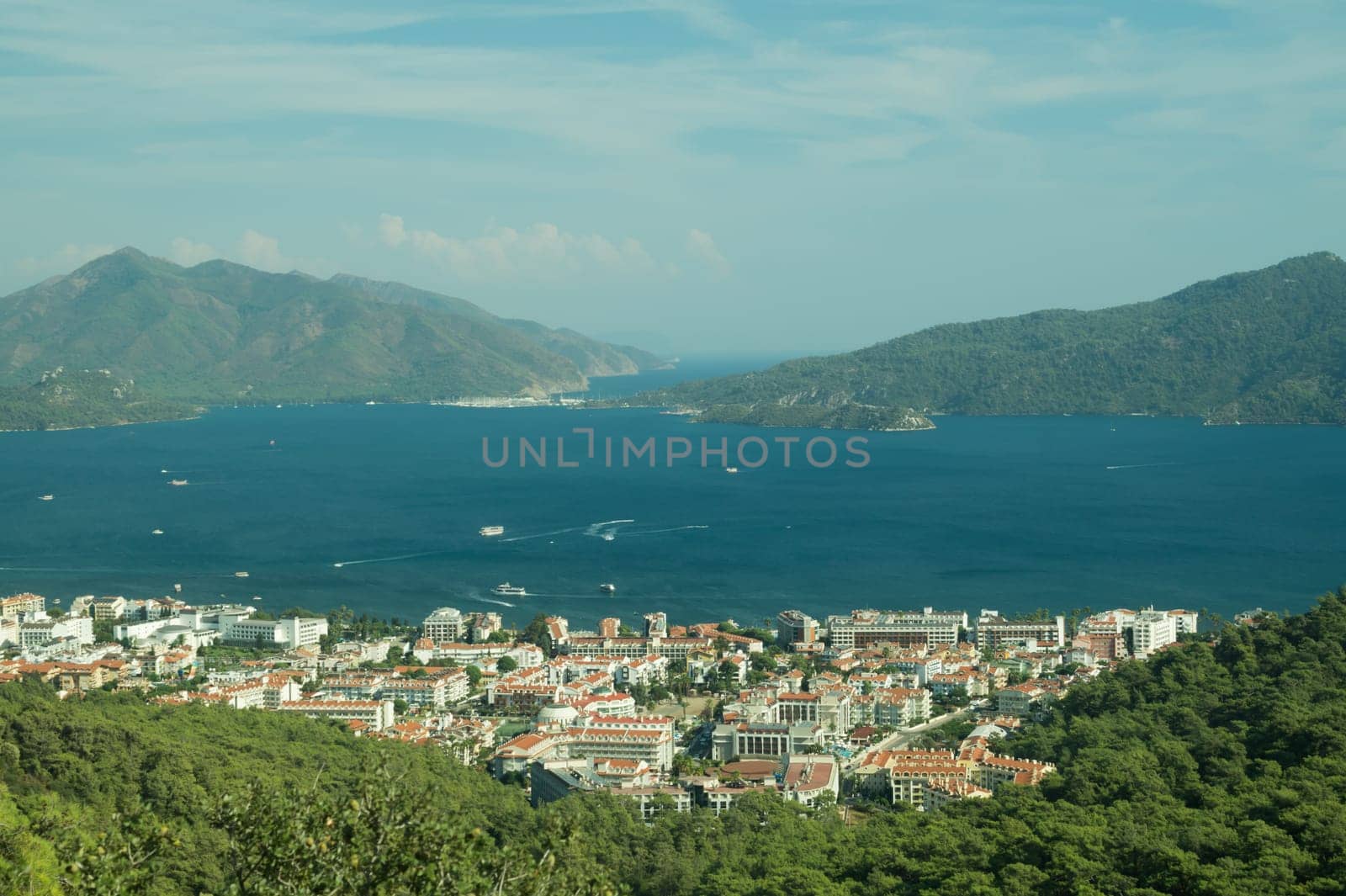 Nature landscape with a city by the shore of the sea between the hills. mountain town panoramic view