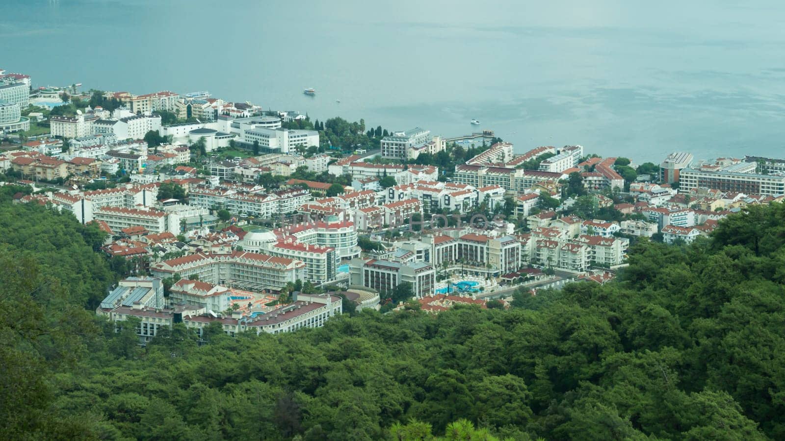 Nature landscape with a city by the shore of the sea between the hills. mountain town panoramic view