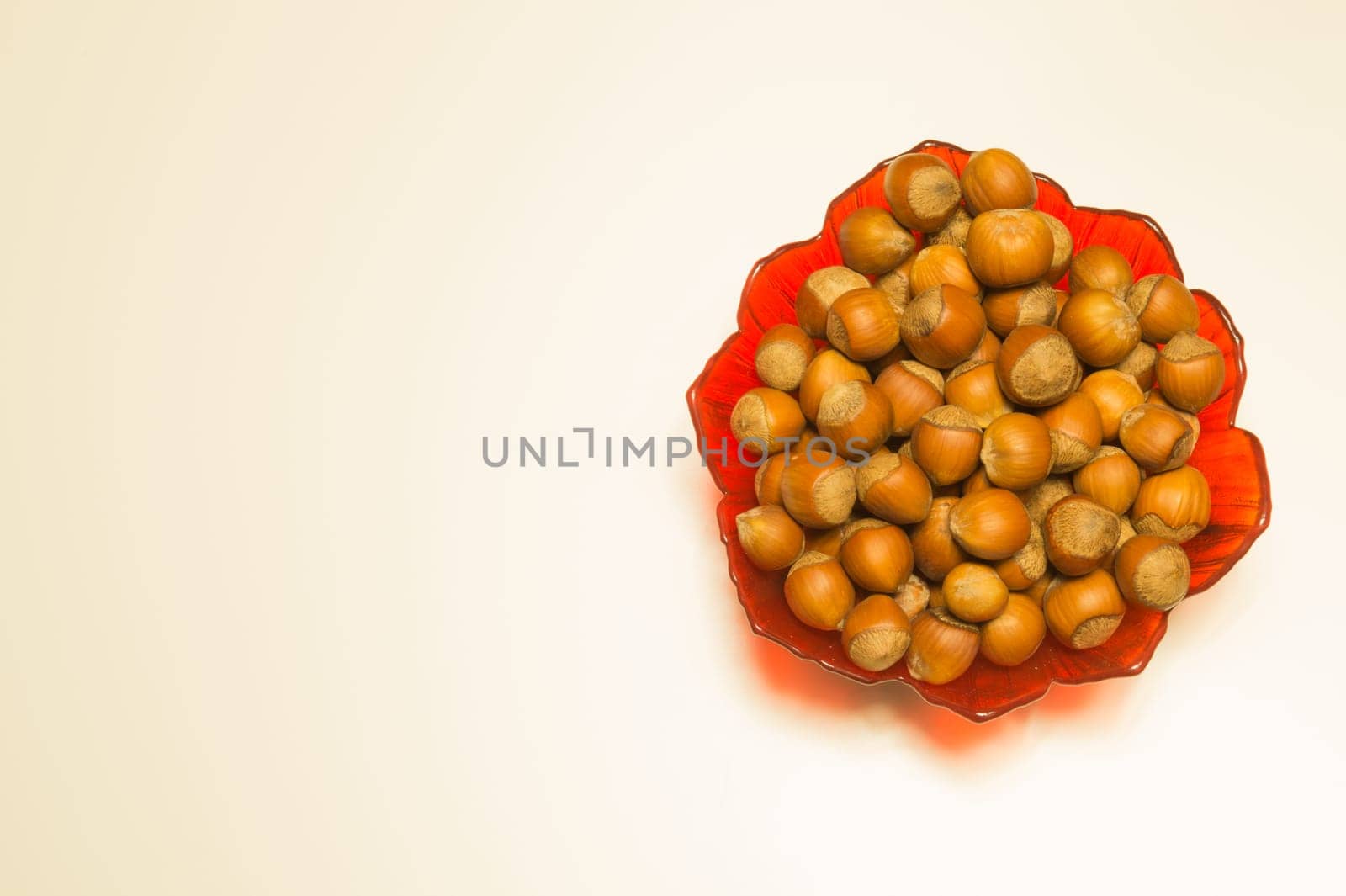 Hazelnuts in a bowl isolated on white. background with copy space