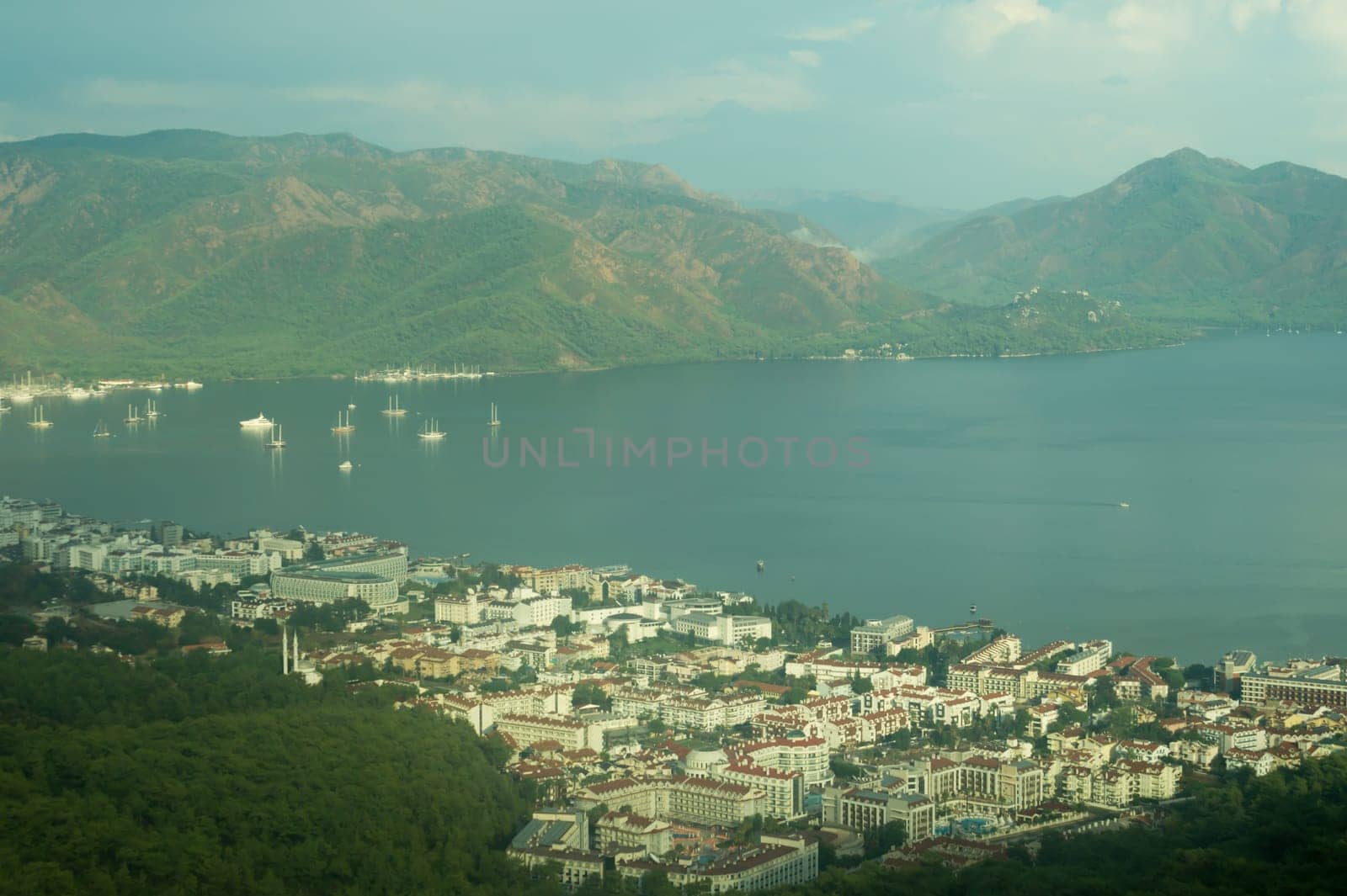 Nature landscape with a city by the shore of the sea between the hills. mountain town panoramic view