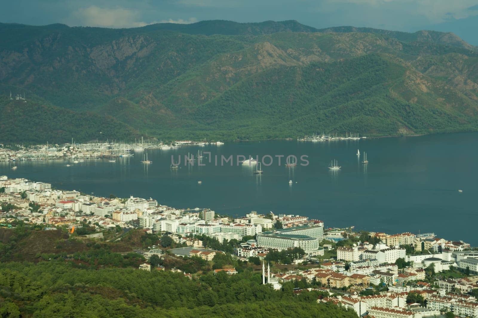 Nature landscape with a city by the shore of the sea between the hills. mountain town panoramic view