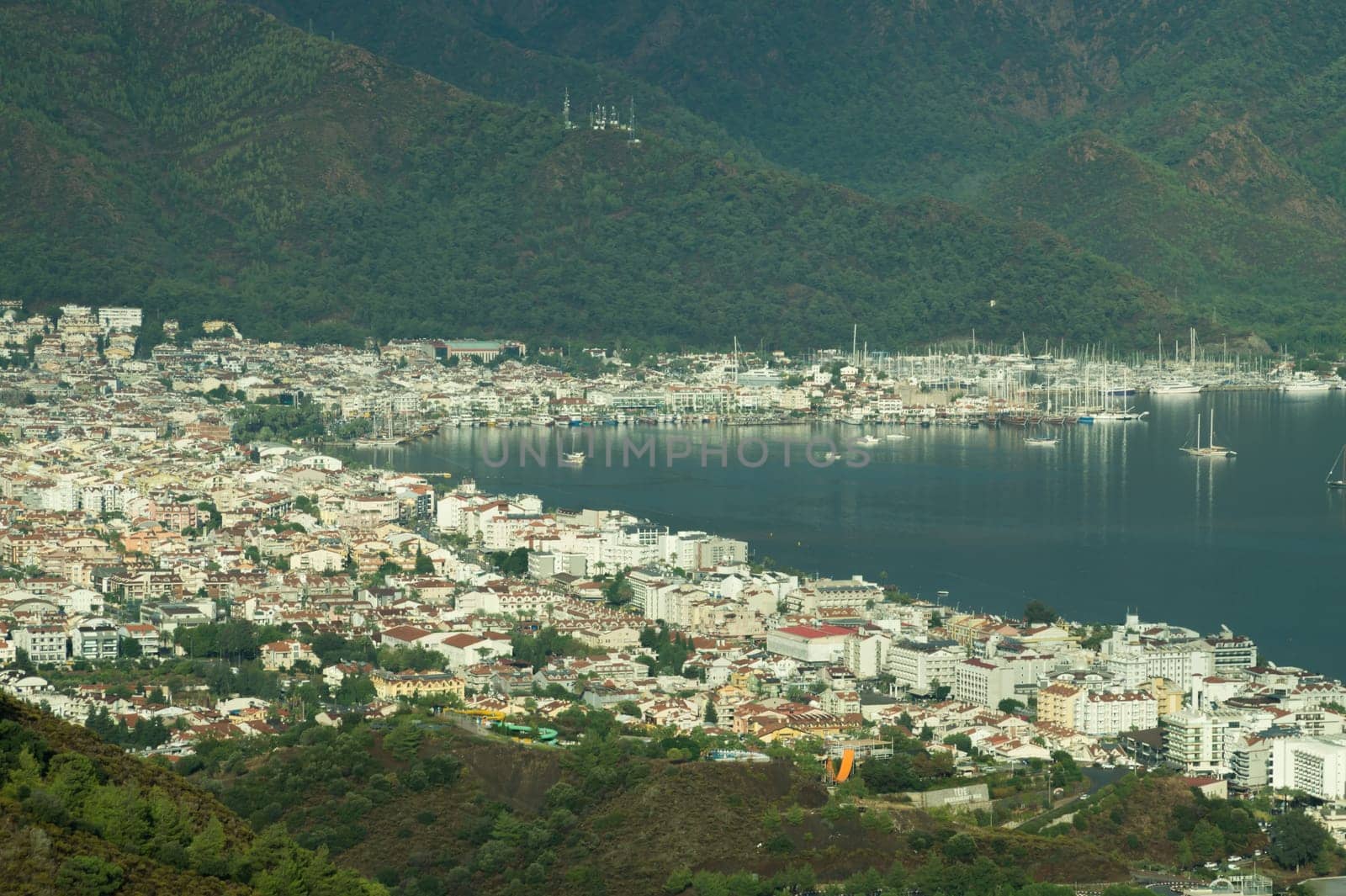 Nature landscape with a city by the shore of the sea between the hills. mountain town panoramic view