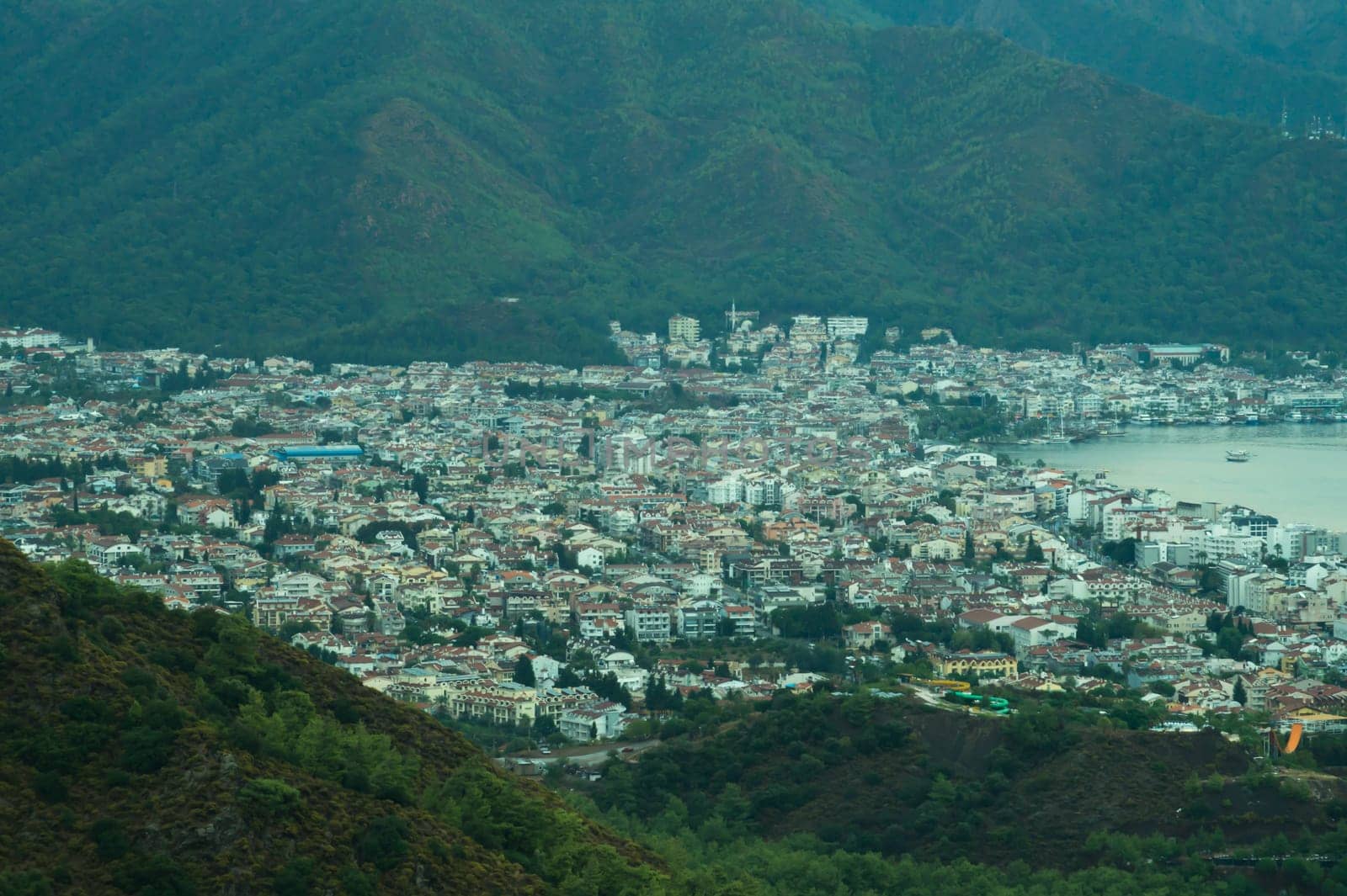 Nature landscape with a city by the shore of the sea between the hills. mountain town panoramic view