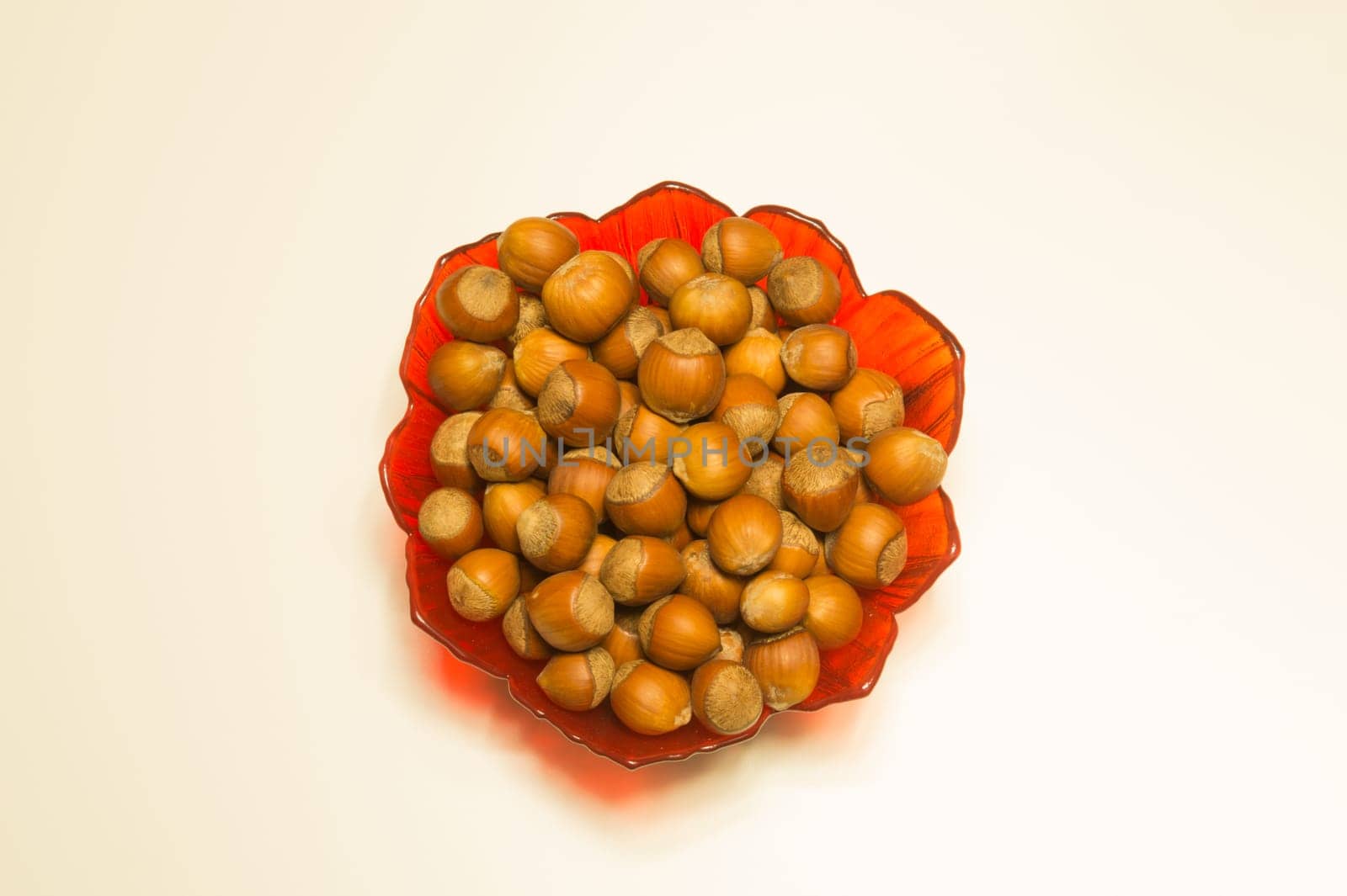 Hazelnuts in a bowl isolated on white. background with copy space