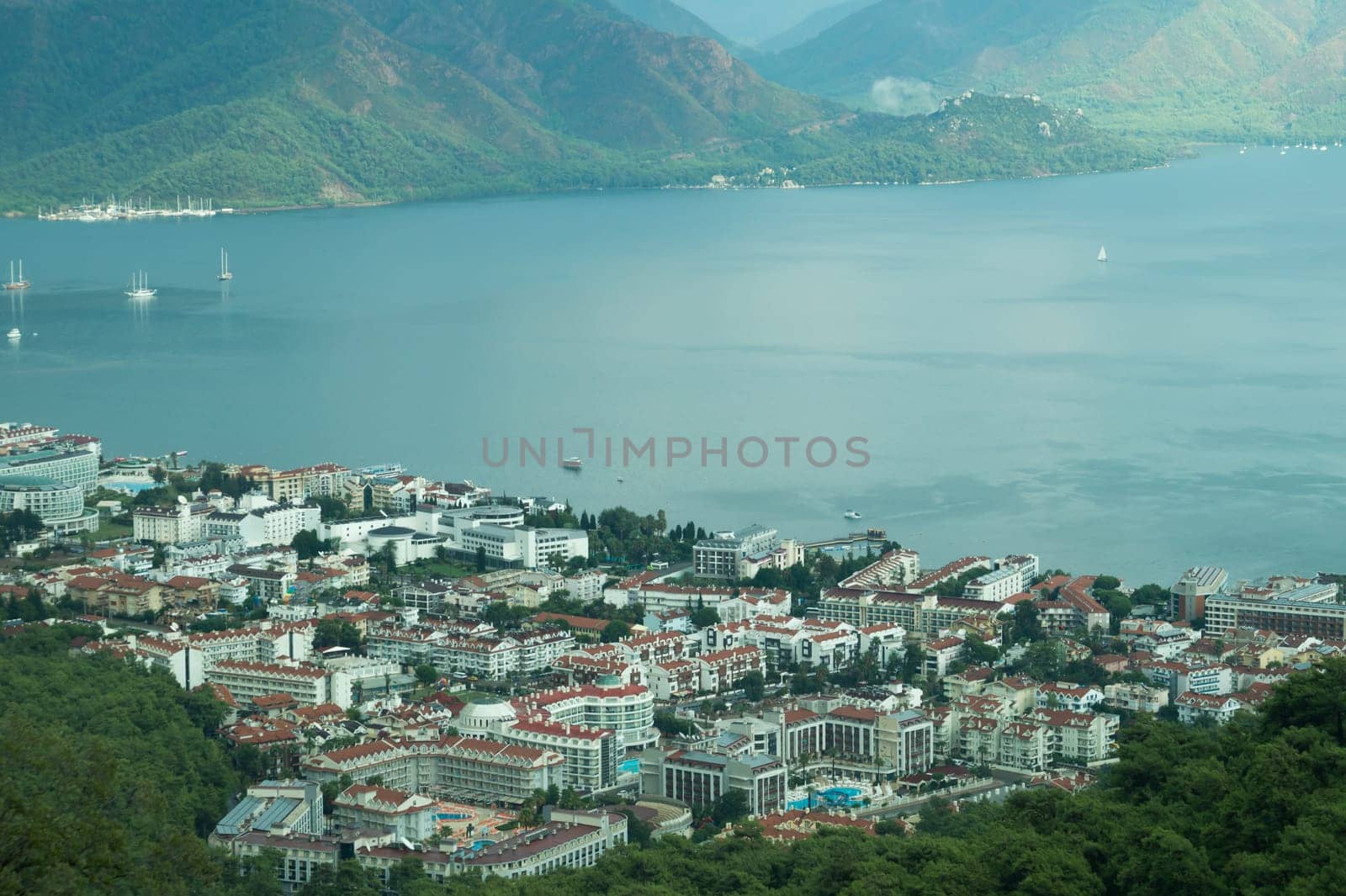 Nature landscape with a city by the shore of the sea between the hills. mountain town panoramic view
