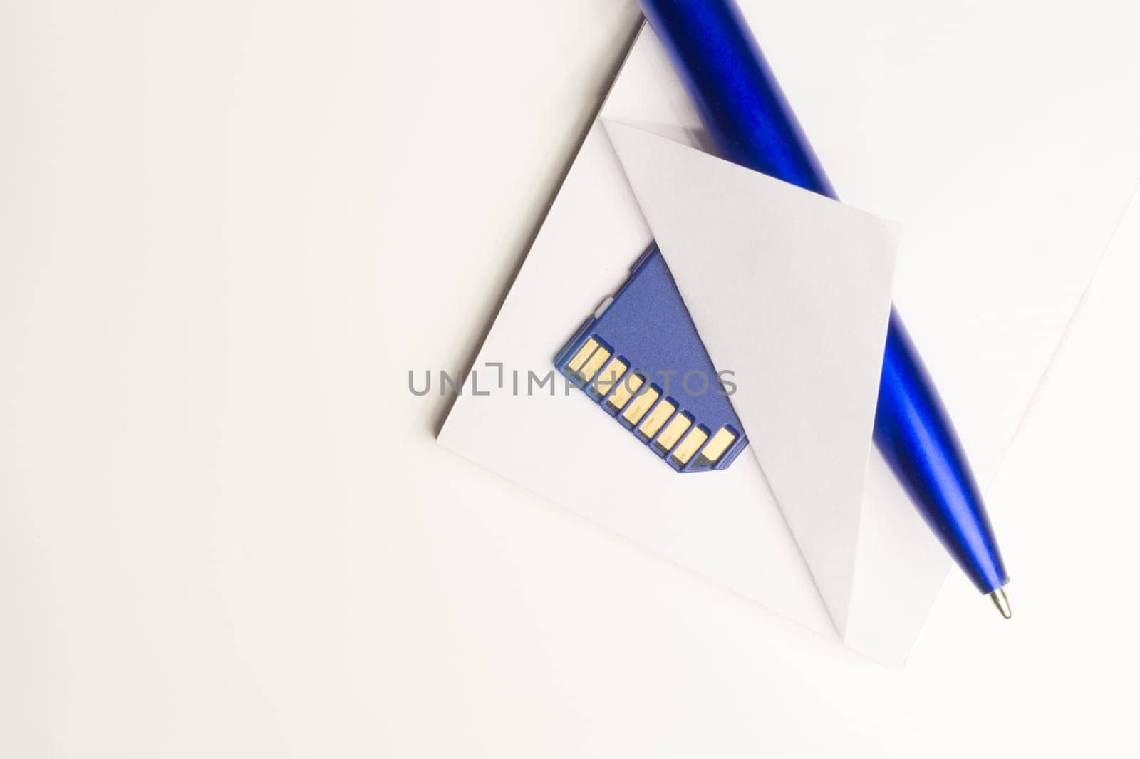 Memory card and blue pen with the paper background