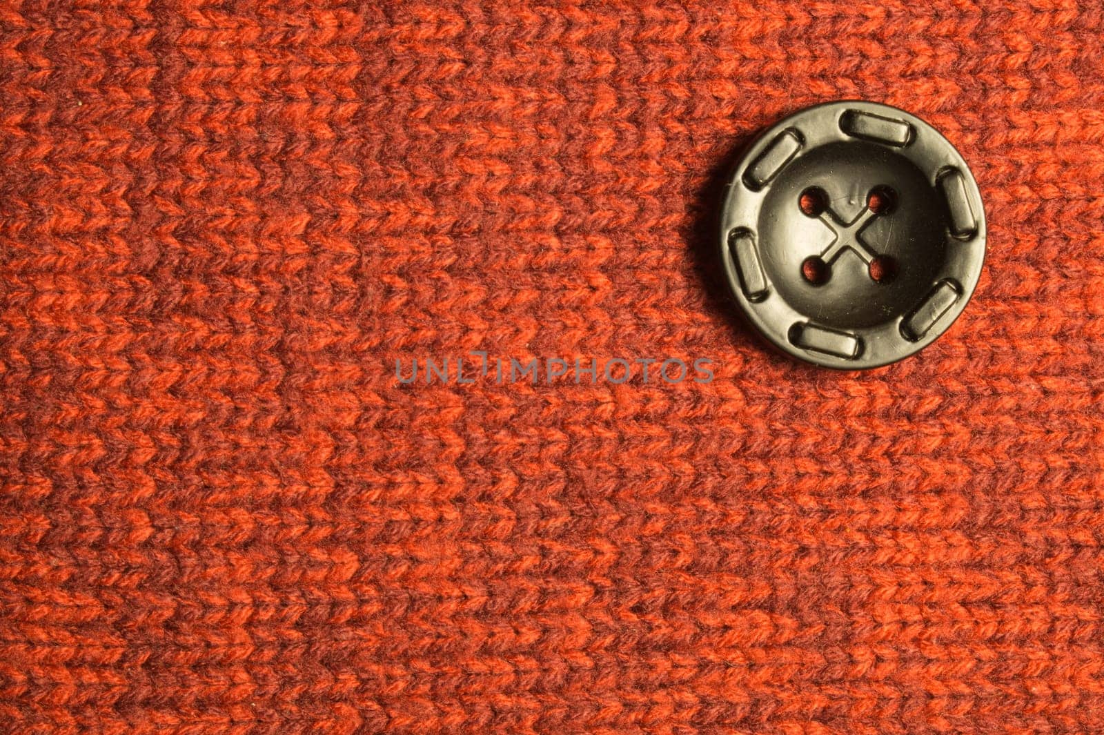 Button on textile background. copy space