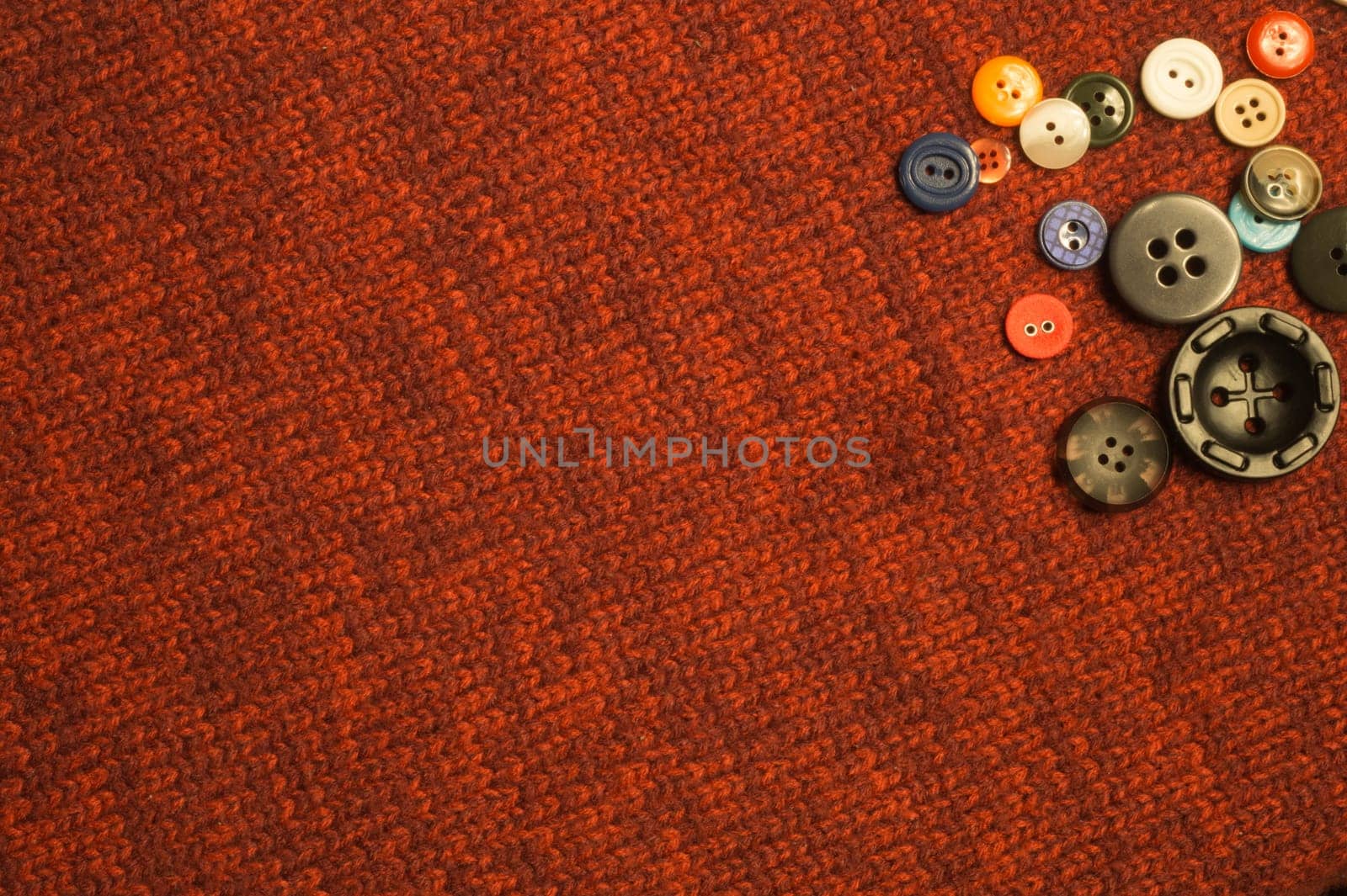 Various sewing buttons on textile background. copy space