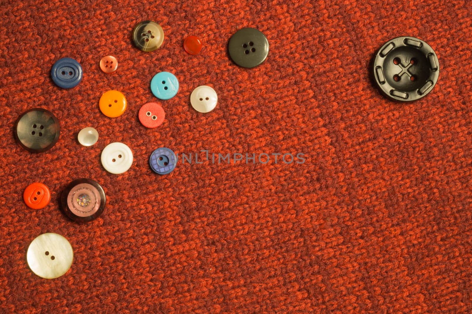 Various sewing buttons on textile background. copy space