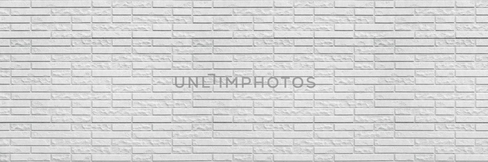 Abstract white brick wall texture background. Horizontal panoramic view of masonry brick wall for interior design.
