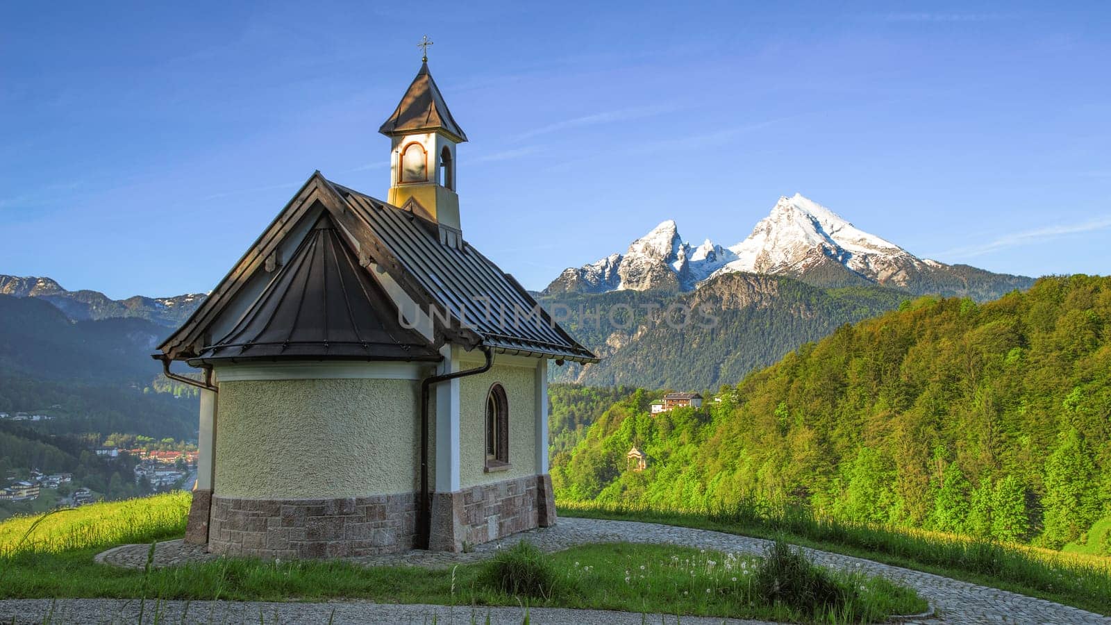 Panoramic spring view beside Berchtesgaden township with mount Watzmann and traditional Kirchleitn chapel