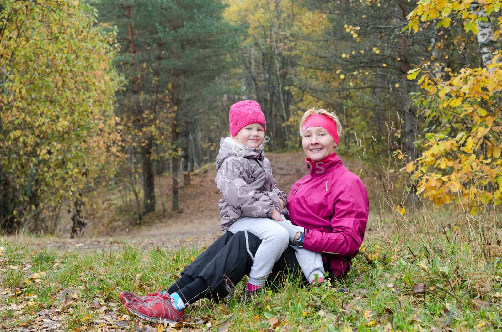 Grandmother with her granddaughter in the autumn park