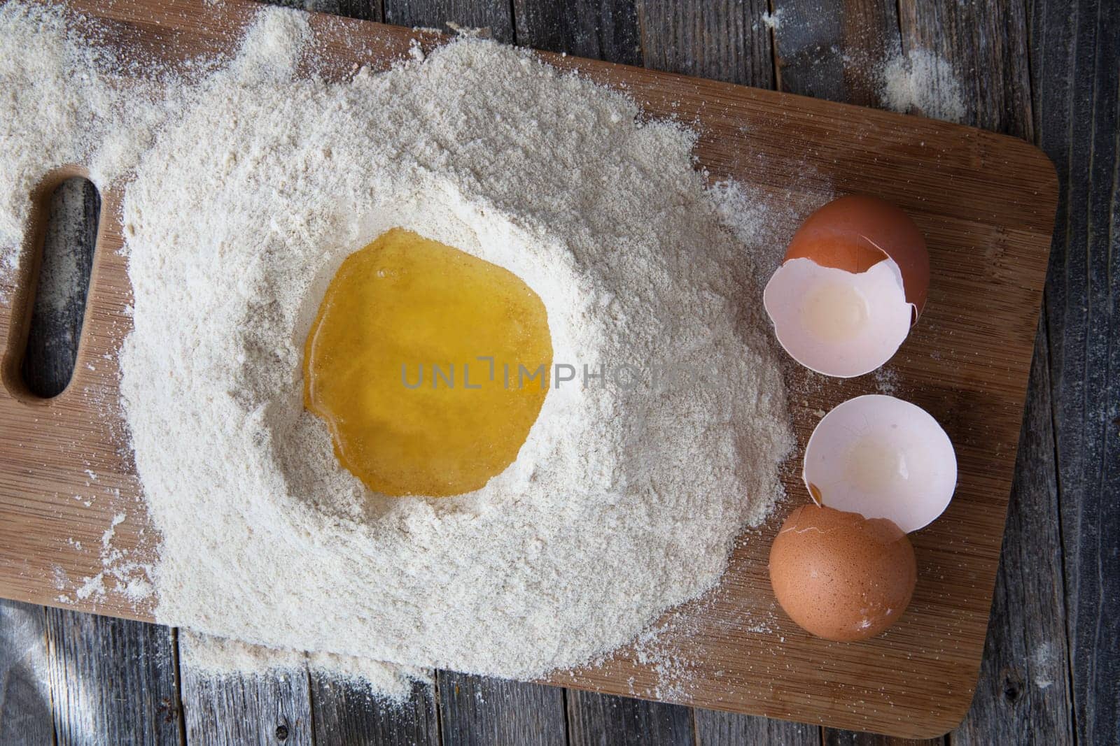 Egg whites in flour with egg shells on the side.