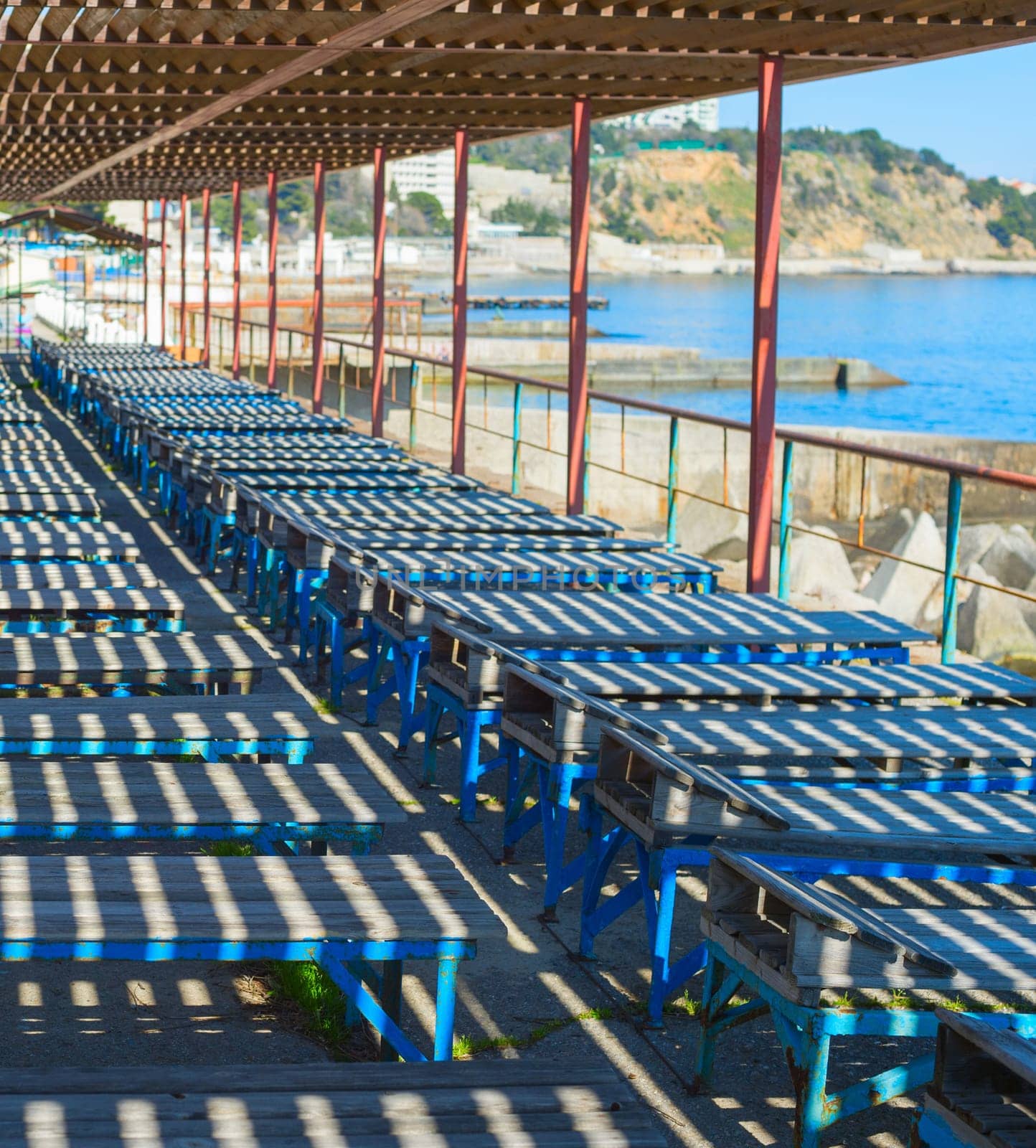 Old wooden deck-chairs on the beach of Crimea. Ukraine